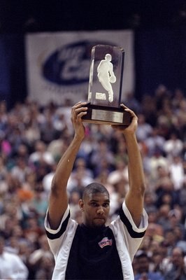 27 Apr 1998: Center Tim Duncan of the San Antonio Spurs holds his Rookie of the Year trophy during an NBA playoff game against the Phoenix Suns at the AlamoDome in San Antonio, Texas. The Spurs defeated the Suns 100-88.