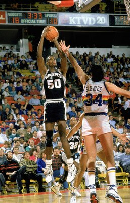 DENVER -1989:  David Robinson #50 of the San Antonio Spurs goes for the jump shot against Danny Schayes #34 of the Denver Nuggets during the game circa 1989 -1990 at the McNichols Sports Arena in Denver, Colorado. (Photo by Tim DeFrisco/Getty Images)