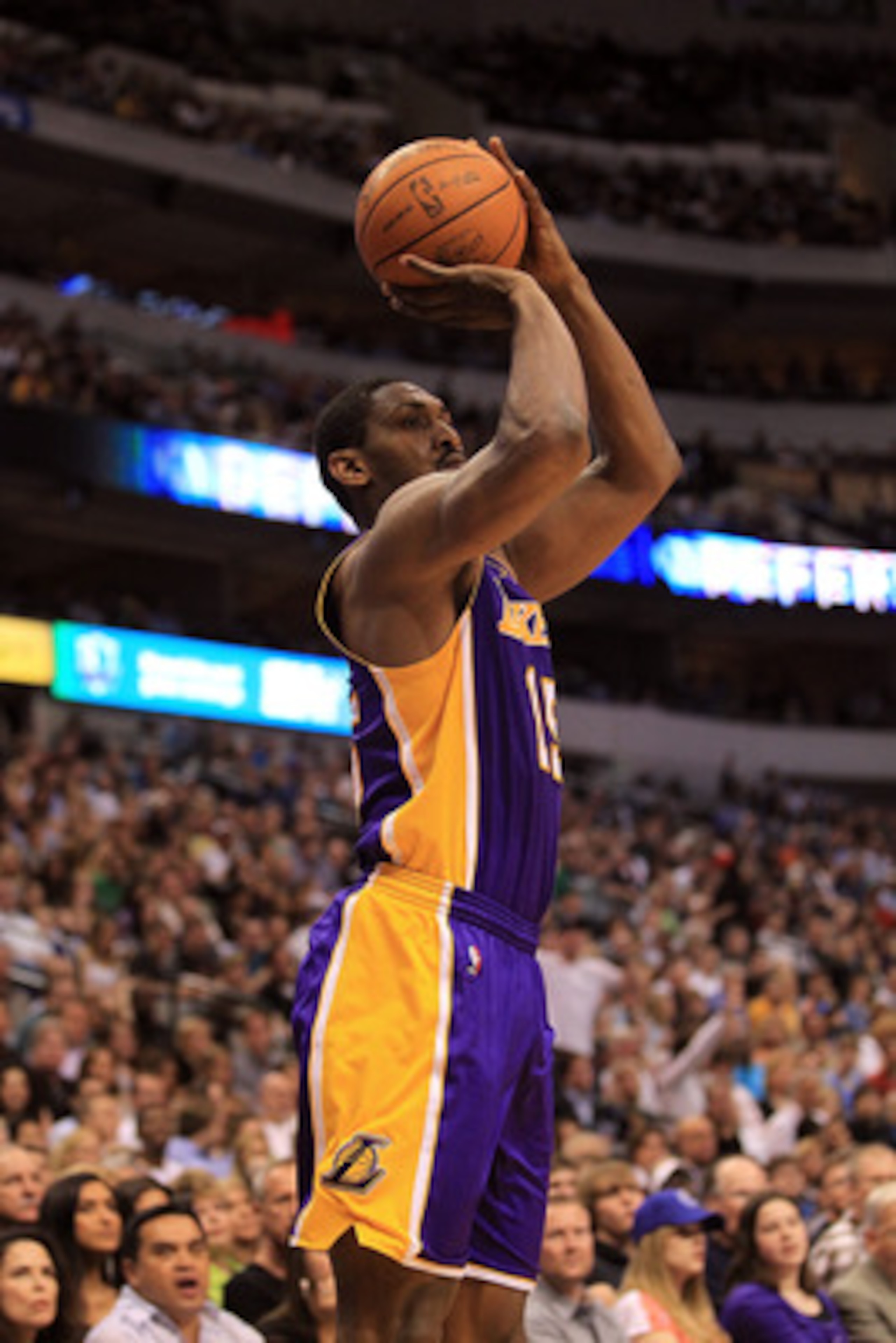 DALLAS, TX - MARCH 12:  Forward Ron Artest #15 of the Los Angeles Lakers makes a three-point shot against the Dallas Mavericks at American Airlines Center on March 12, 2011 in Dallas, Texas.  NOTE TO USER: User expressly acknowledges and agrees that, by d