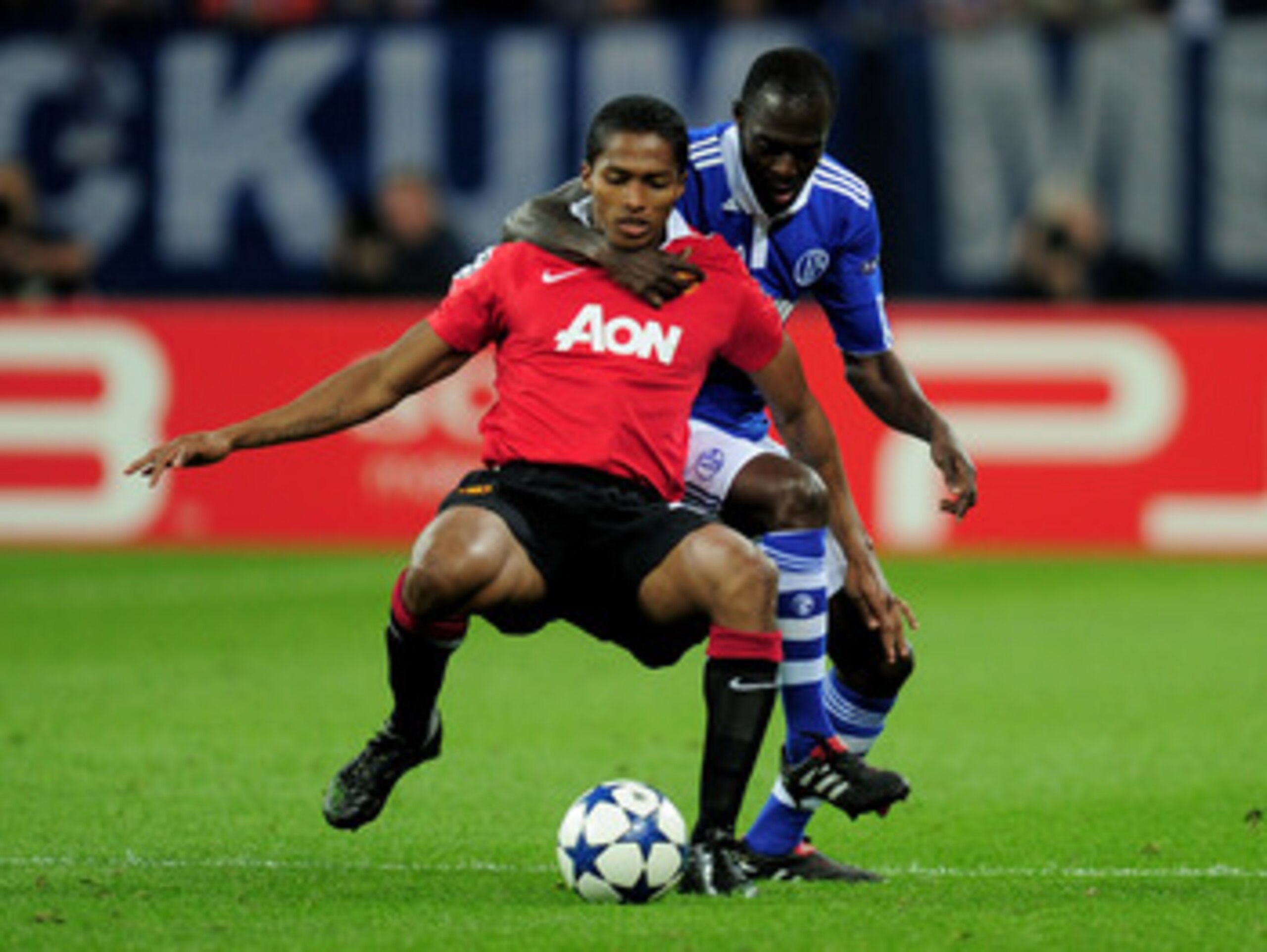 GELSENKIRCHEN, GERMANY - APRIL 26:  Hans Sarpei of Schalke tangles with Antonio Valencia of Manchester United during the UEFA Champions League Semi Final first leg match between FC Schalke 04 and Manchester United at Veltins Arena on April 26, 2011 in Gel
