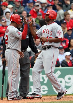 BOSTON, MA - MAY 05:  Erick Aybar #2 of the Los Angeles Angels cekebrates with teammate Torii Hunter #48 after they both scored in the third inning against the Boston Red Sox on May 5, 2011 at Fenway Park in Boston, Massachusetts.  (Photo by Elsa/Getty Im
