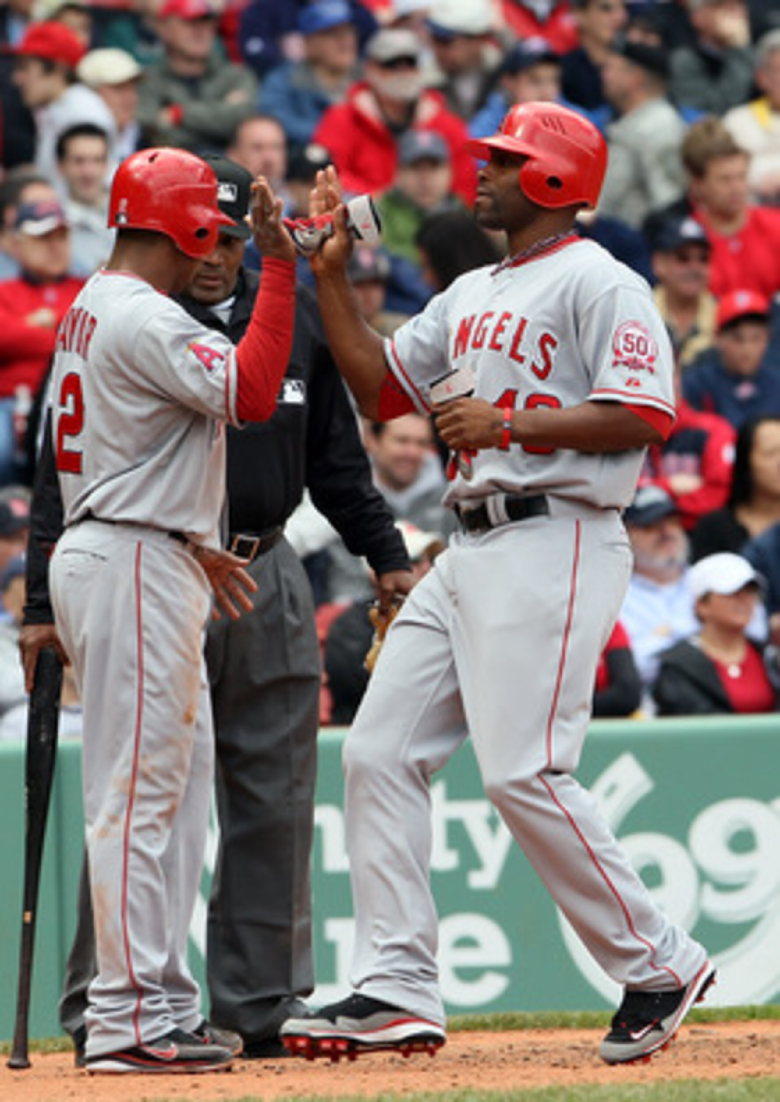 BOSTON, MA - MAY 05:  Erick Aybar #2 of the Los Angeles Angels cekebrates with teammate Torii Hunter #48 after they both scored in the third inning against the Boston Red Sox on May 5, 2011 at Fenway Park in Boston, Massachusetts.  (Photo by Elsa/Getty Im