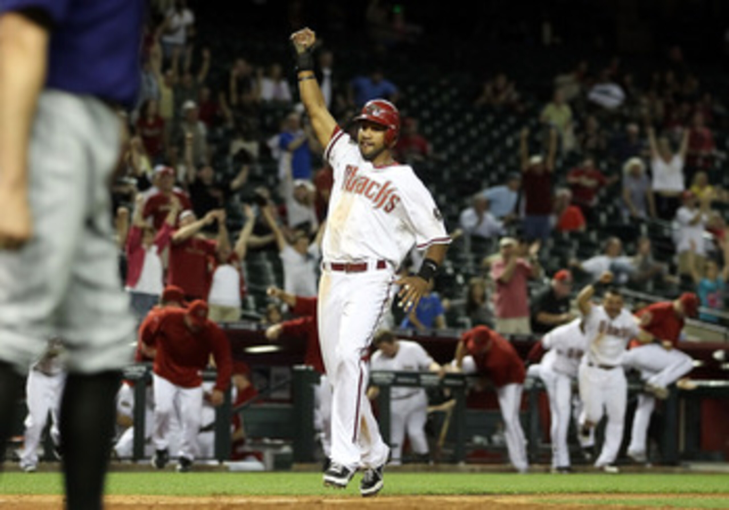 PHOENIX, AZ - MAY 05:  Chris Young #24 of the Arizona Diamondbacks celebrates as he scores the game winning run against the Colorado Rockies in 11th inning of the Major League Baseball game at Chase Field on May 5, 2011 in Phoenix, Arizona.  The Diamondba