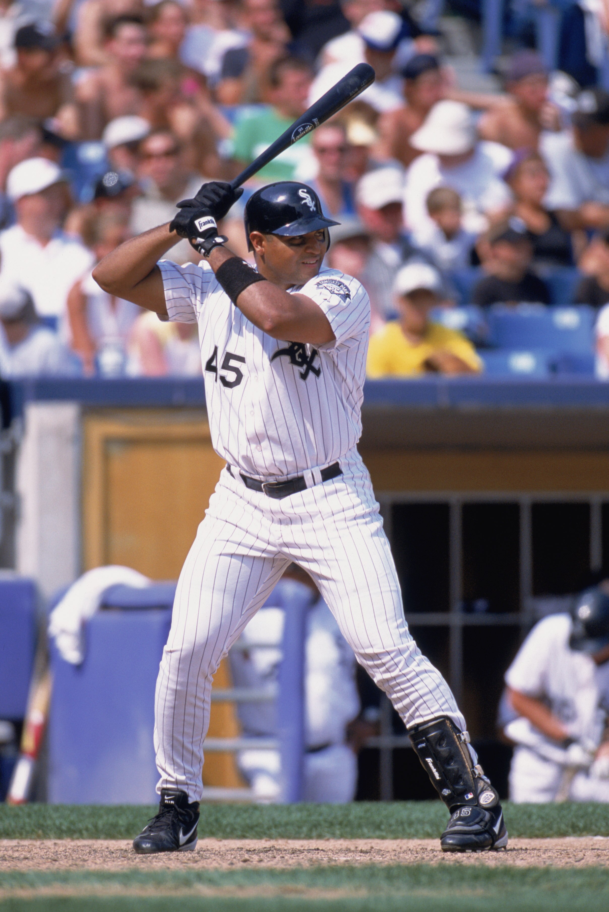 CHICAGO - AUGUST 11:  Carlos Lee #45 of the Chicago White Sox waits for the pitch during the game against the Seattle Mariners at Comiskey Park in Chicago, Illinois on August 11, 2002. The White Sox defeated the Mariners 6-5. (Photo by:  Jonathan Daniel/G