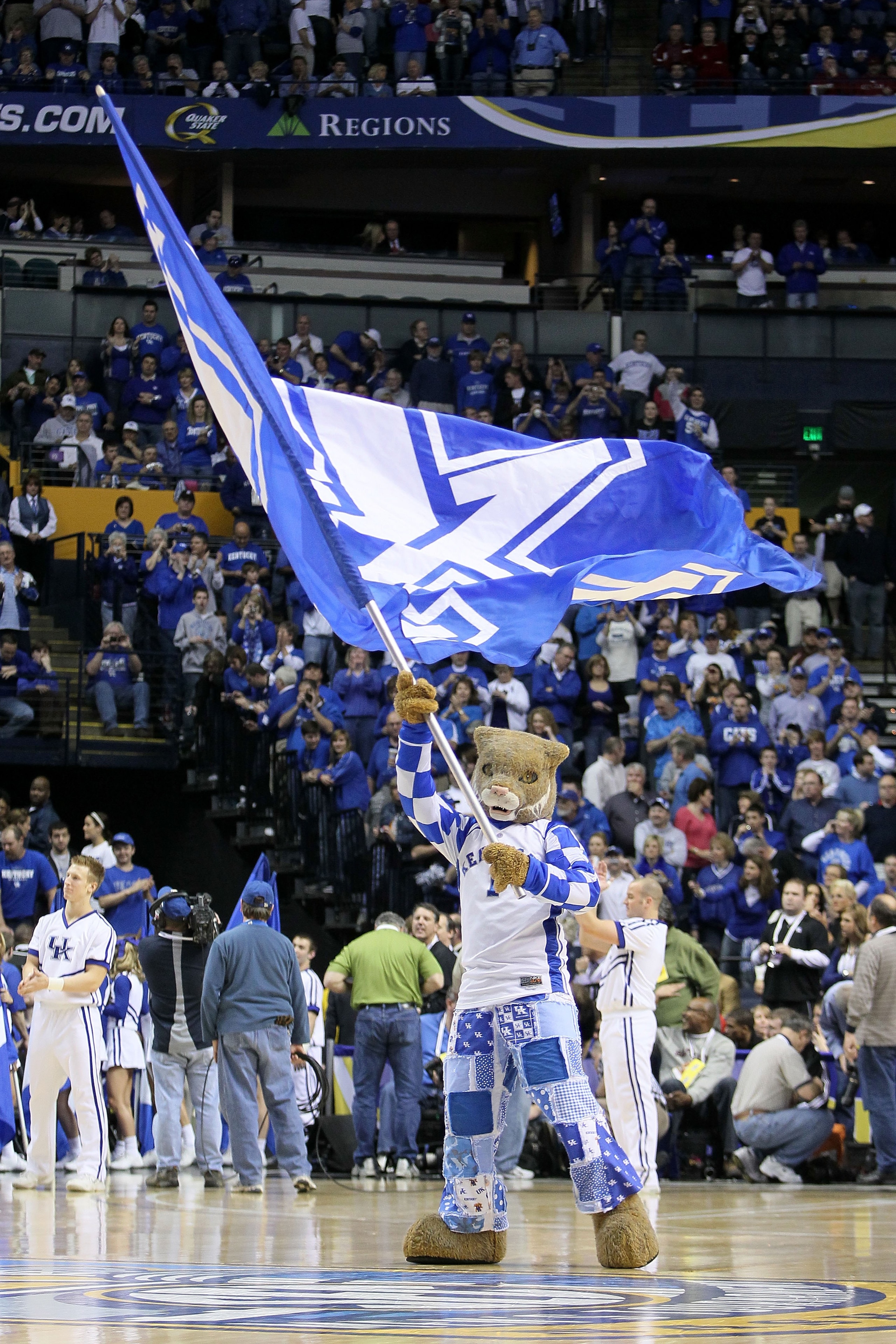 NASHVILLE, TN - MARCH 14:  The Wildcat, mascot for the Kentucky Wildcats waves a giant UK flag as he performs against the Mississippi State Bulldogs during the final of the SEC Men's Basketball Tournament at the Bridgestone Arena on March 14, 2010 in Nash