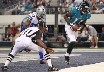 ARLINGTON, TX - OCTOBER 31:  Wide receiver Mike Sims-Walker #11 of the Jacksonville Jaguars makes a touchdown pass reception against Alan Ball #20 of the Dallas Cowboys in the first quarter at Cowboys Stadium on October 31, 2010 in Arlington, Texas.  (Pho