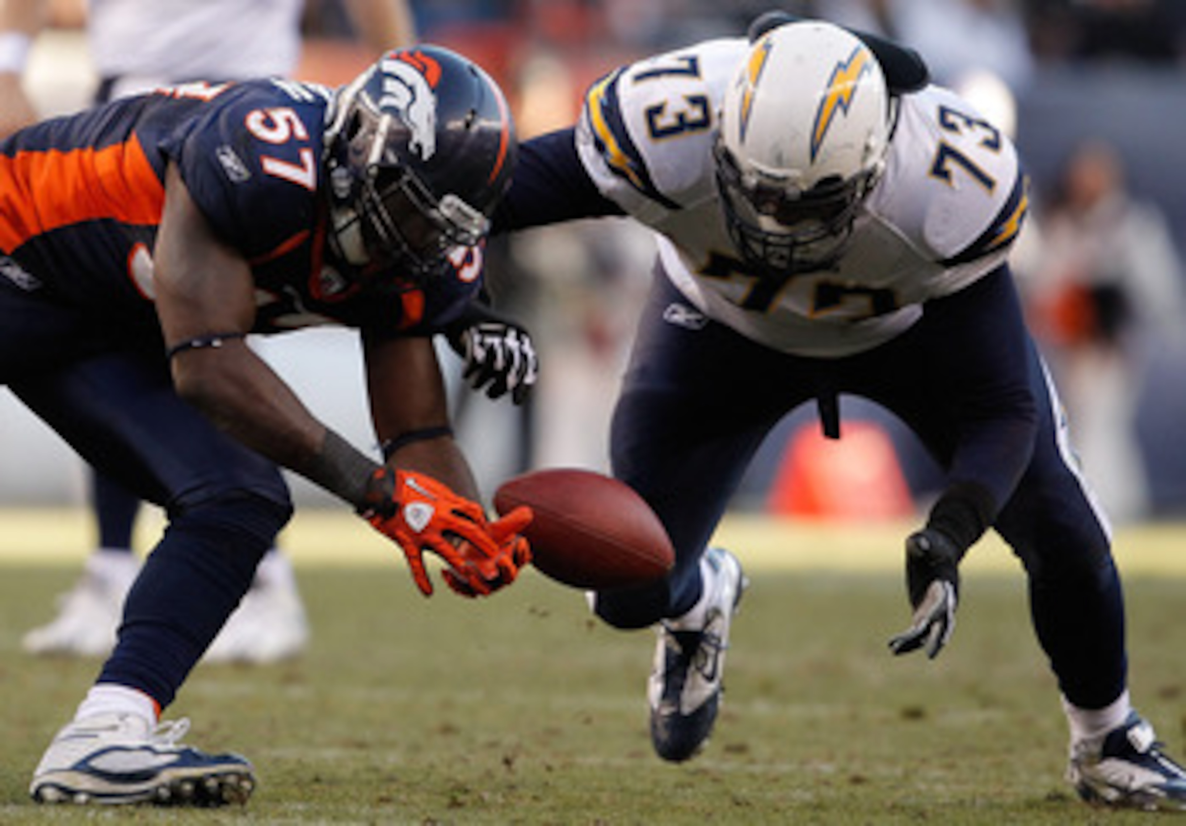 DENVER, CO - JANUARY 2:  Linebacker Mario Haggan #57 of the Denver Broncos and offensive tackle Marcus McNeill #73 of the San Diego Chargers battle for the ball following a fumble by runningback Ryan Mathews #24 of the San Diego Chargers during the second