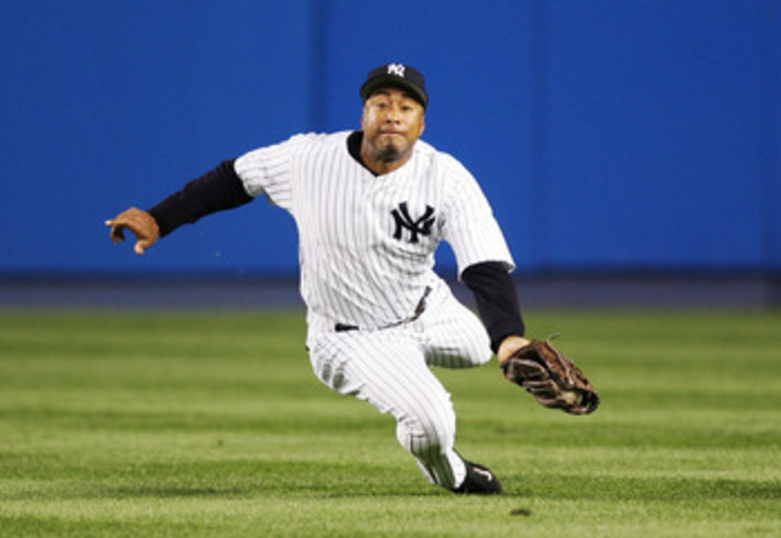 NEW YORK - MAY 29:  Center fielder Bernie Williams #51 of the New York Yankees makes a diving catch on a hit by Johnny Damon #18 of the Boston Red Sox in the fourth inning of the game at Yankee Stadium on May 29, 2005 in the Bronx borough of New York City