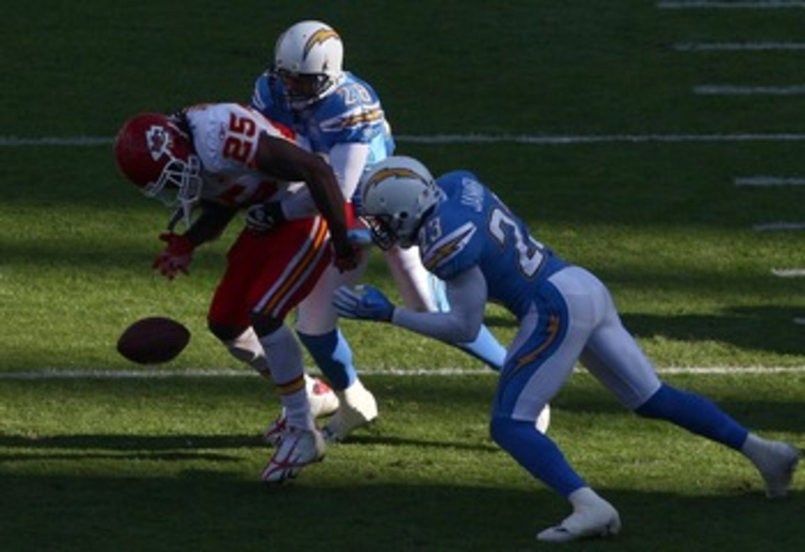SAN DIEGO, CA - NOVEMBER 29:   Steve Gregory #28 and Quentin Jammer #23 of the San Diego Chargers forces a fumble by Runningback Jamaal Charles #25 of the Kansas City Chiefs during the NFL game on November 29, 2009 at Qualcomm Stadium in San Diego, Califo
