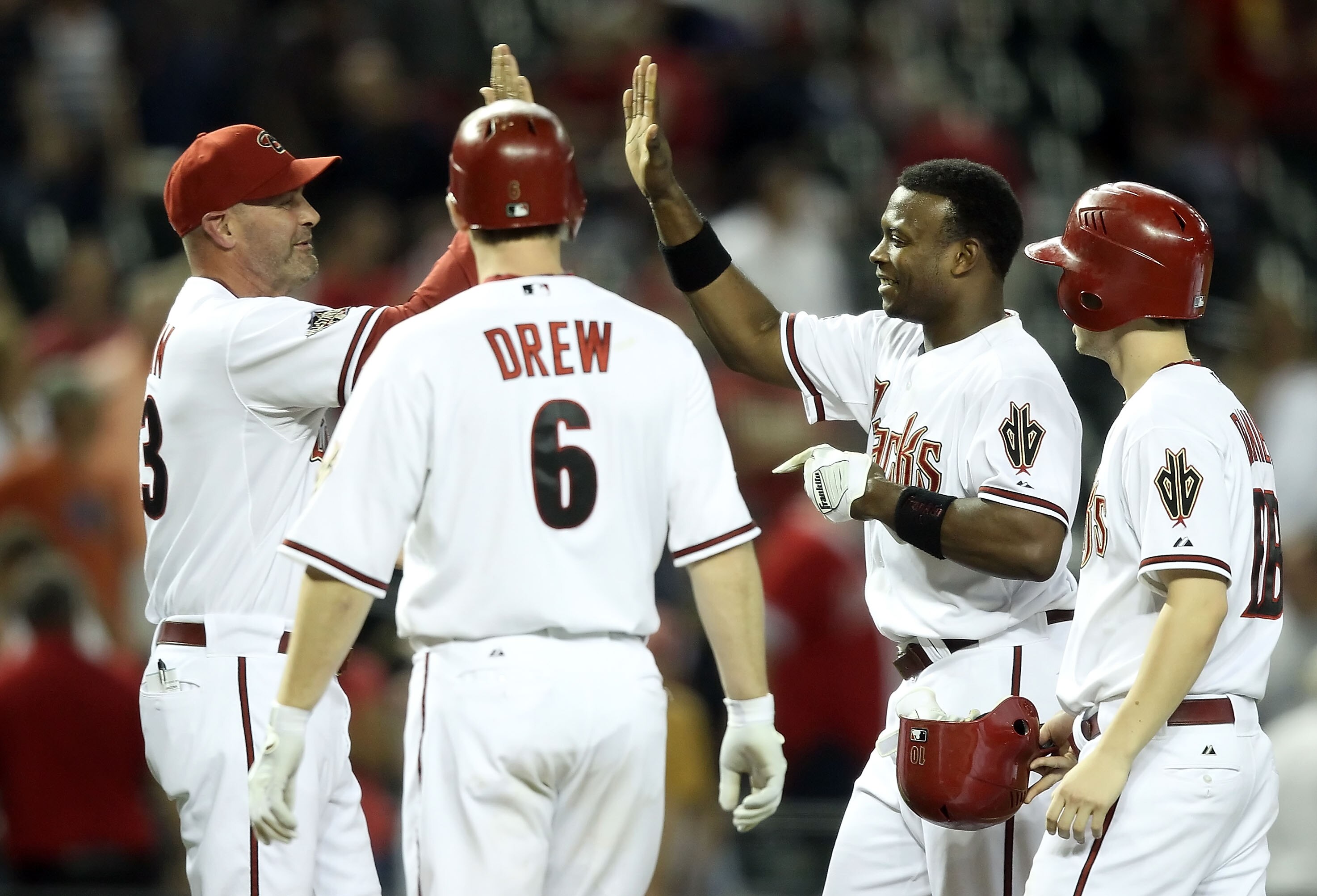 PHOENIX, AZ - MAY 05:  Manager Kirk Gibson of the Arizona Diamondbacks high fives Justin Upton #10 after his game winning RBI single against the Colorado Rockies during the 11th inning of the Major League Baseball game at Chase Field on May 5, 2011 in Pho