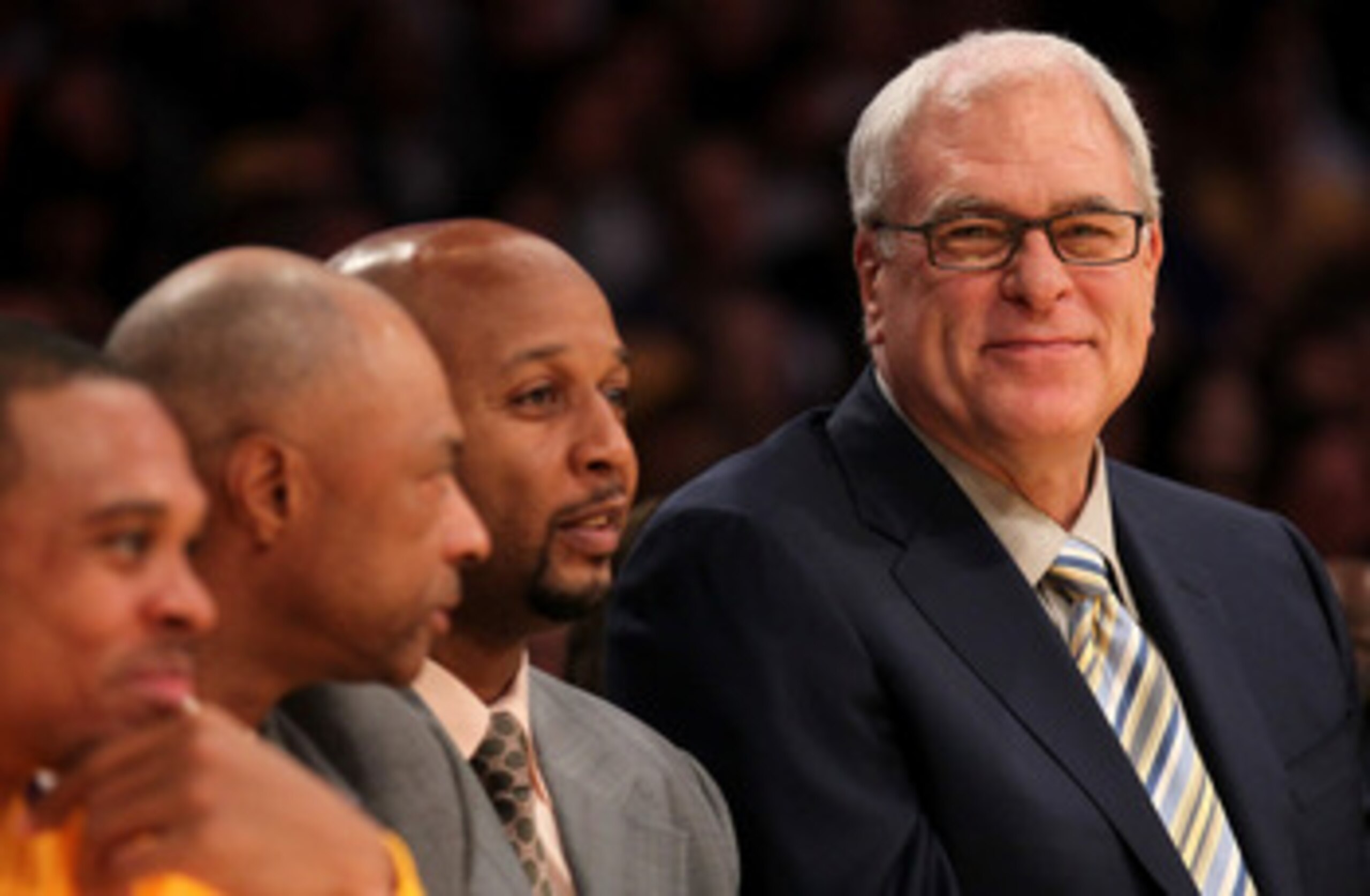 LOS ANGELES, CA - NOVEMBER 05:  Head coach Phil Jackson (L) of the Los Angeles Lakers smiles on the bench next to assistants Brian Shaw (C) and Jim Cleamons during the game with the Toronto Raptors at Staples Center on November 5, 2010 in Los Angeles, Cal