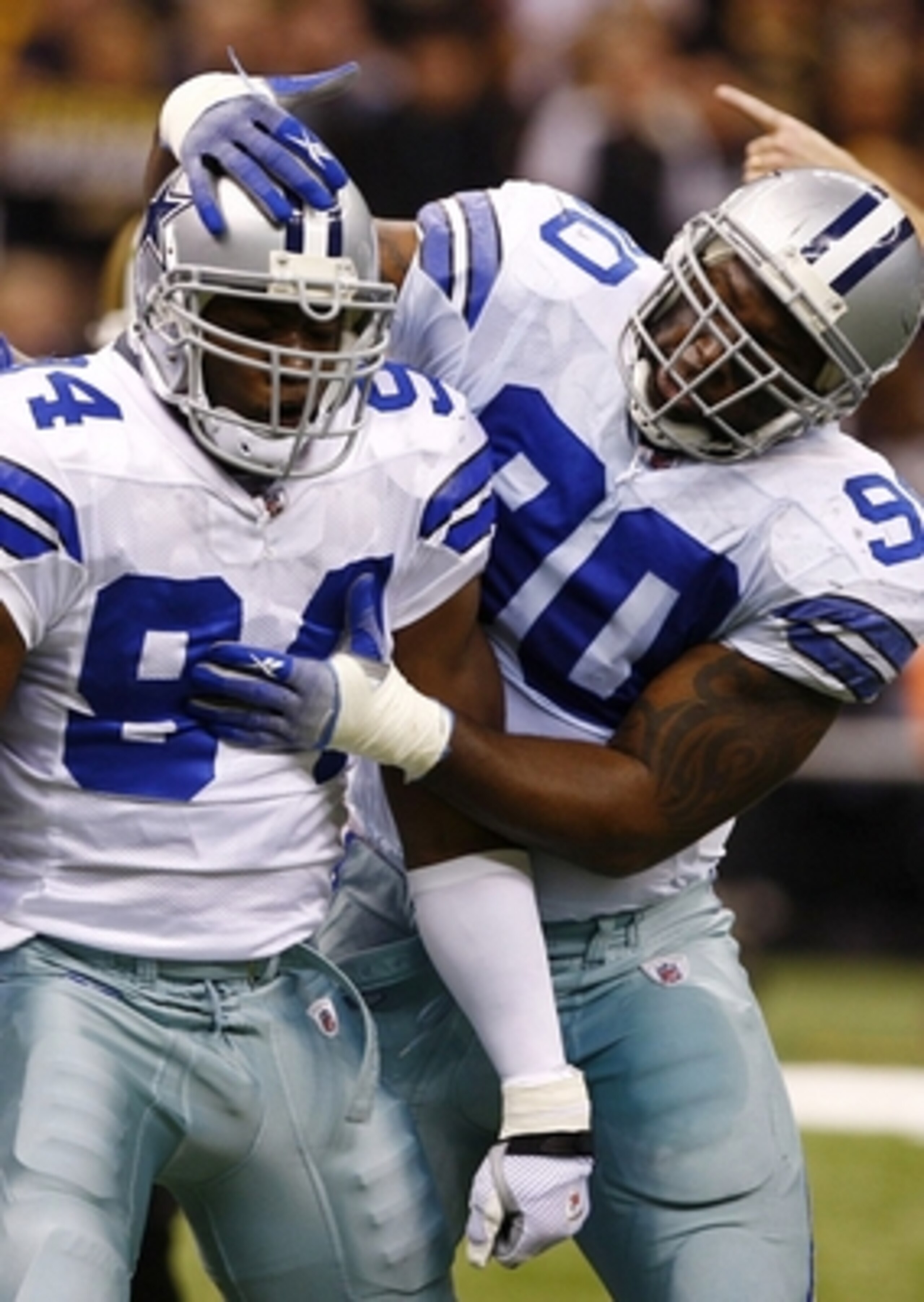 NEW ORLEANS - DECEMBER 19:  Linebacker DeMarcus Ware #94 of the Dallas Cowboys celebrates with defensive ends Jay Ratliff (R) #90 and Stephen Bowen (L) #72 after a sack against the New Orleans Saints at the Louisiana Superdome on December 19, 2009 in New