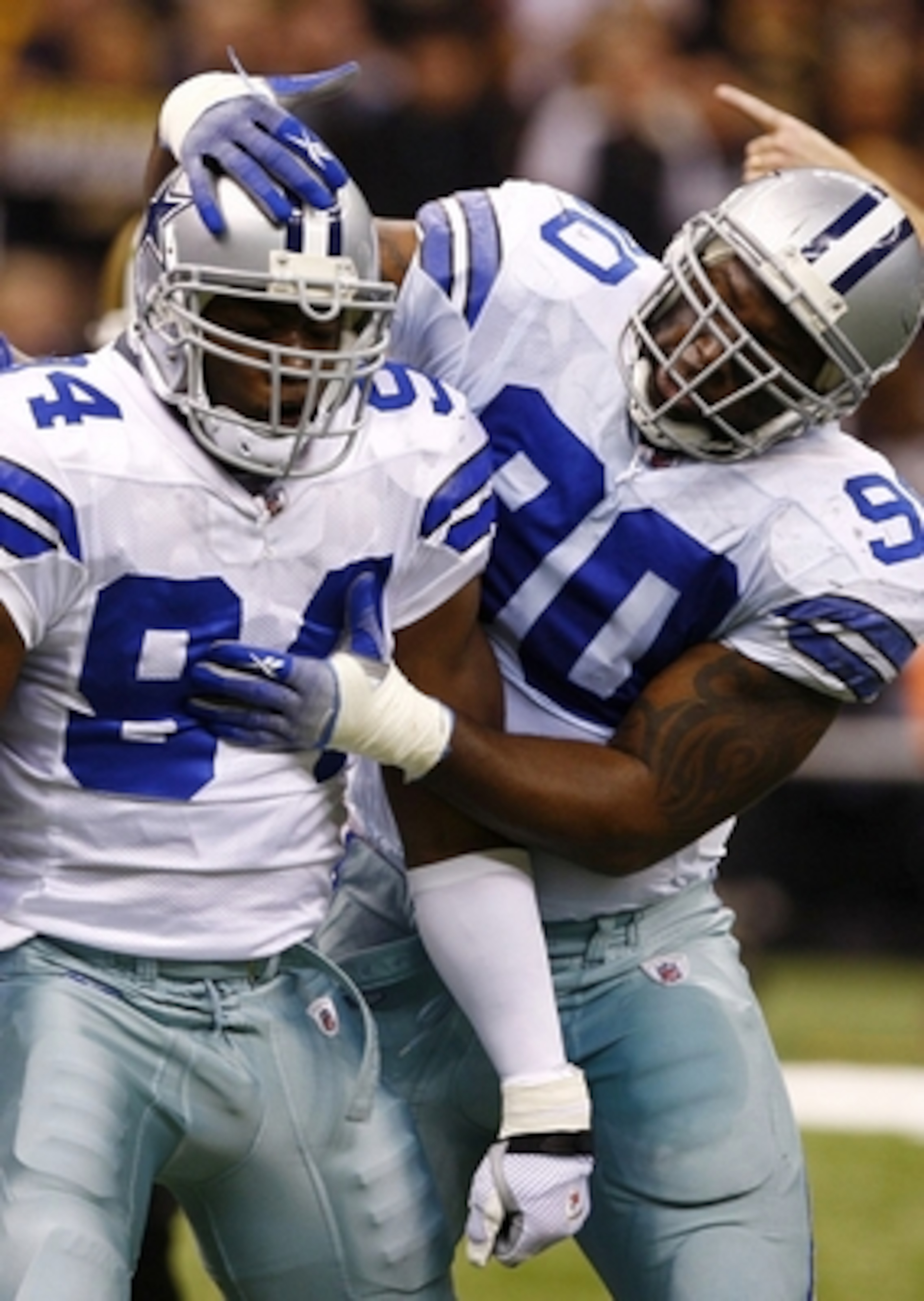 NEW ORLEANS - DECEMBER 19:  Linebacker DeMarcus Ware #94 of the Dallas Cowboys celebrates with defensive ends Jay Ratliff (R) #90 and Stephen Bowen (L) #72 after a sack against the New Orleans Saints at the Louisiana Superdome on December 19, 2009 in New