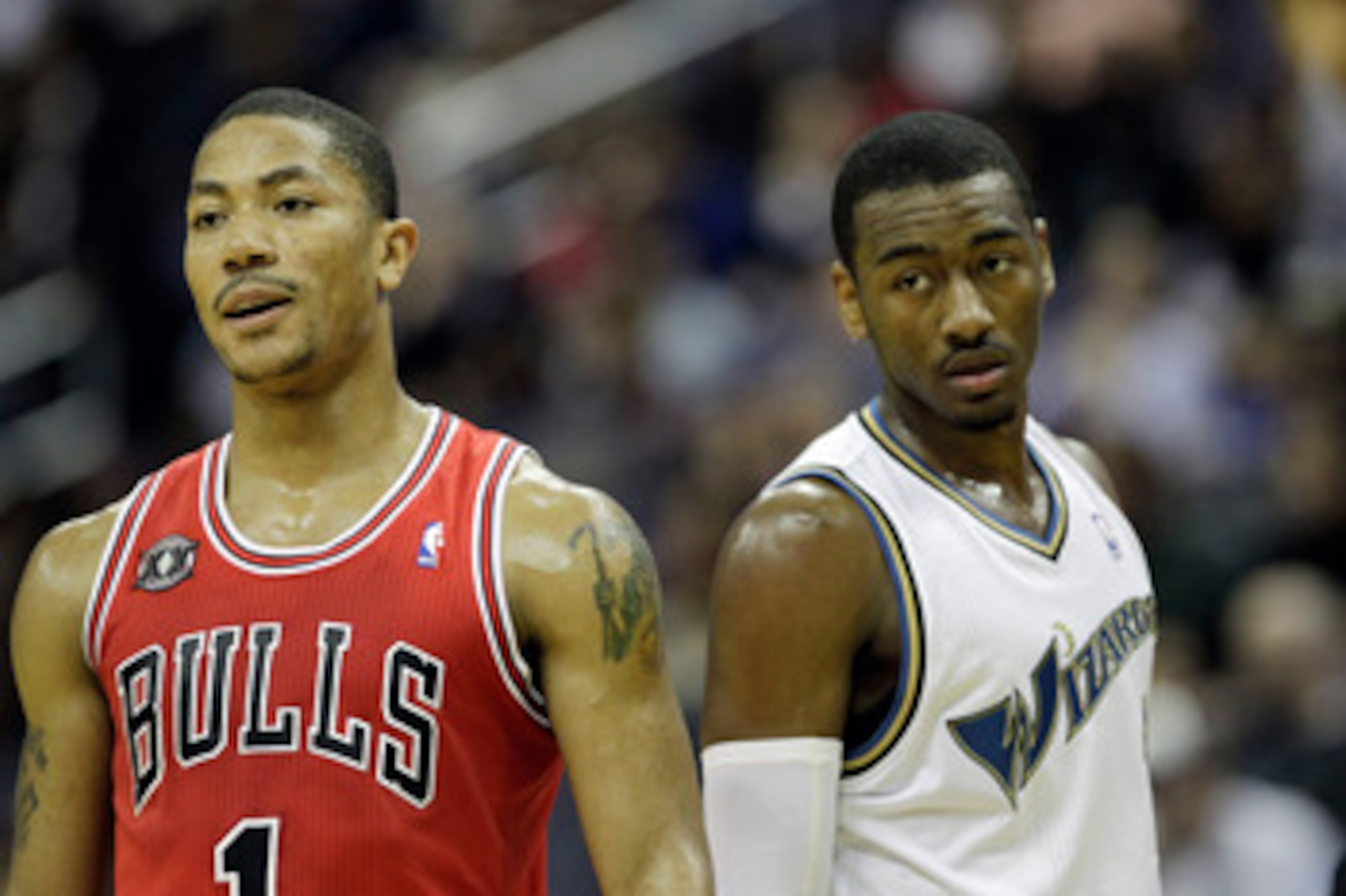 WASHINGTON, DC - FEBRUARY 28: John Wall #2 of the Washington Wizards (R) and Derrick Rose #1 of the Chicago Bulls (L) watch a foul shot at the Verizon Center in Washington on February 28, 2011 in Washington, DC. NOTE TO USER: User expressly acknowledges a