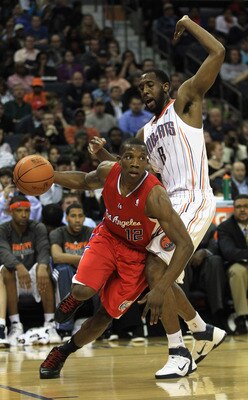 CHARLOTTE, NC - MARCH 07:  Eric Bledsoe #12 of the Los Angeles Clippers drives past DJ White #8 of the Charlotte Bobcats during their game at Time Warner Cable Arena on March 7, 2011 in Charlotte, North Carolina. NOTE TO USER: User expressly acknowledges