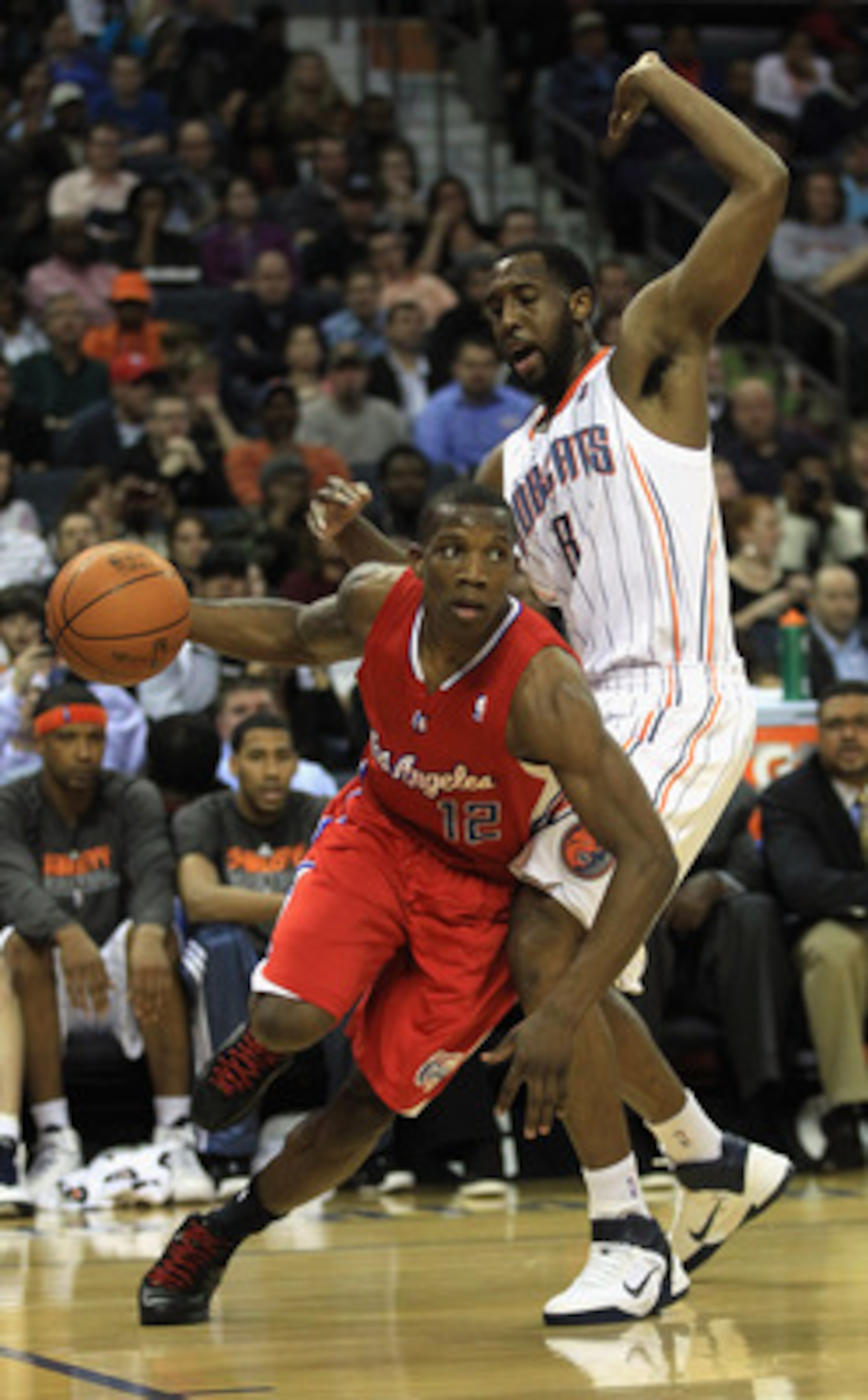 CHARLOTTE, NC - MARCH 07: Eric Bledsoe #12 of the Los Angeles Clippers drives past DJ White #8 of the Charlotte Bobcats during their game at Time Warner Cable Arena on March 7, 2011 in Charlotte, North Carolina. NOTE TO USER: User expressly acknowledges CHARLOTTE, NC - MARCH 07: Eric Bledsoe #12 of the Los Angeles Clippers drives past DJ White #8 of the Charlotte Bobcats during their game at Time Warner Cable Arena on March 7, 2011 in Charlotte, North Carolina. NOTE TO USER: User expressly acknowledges