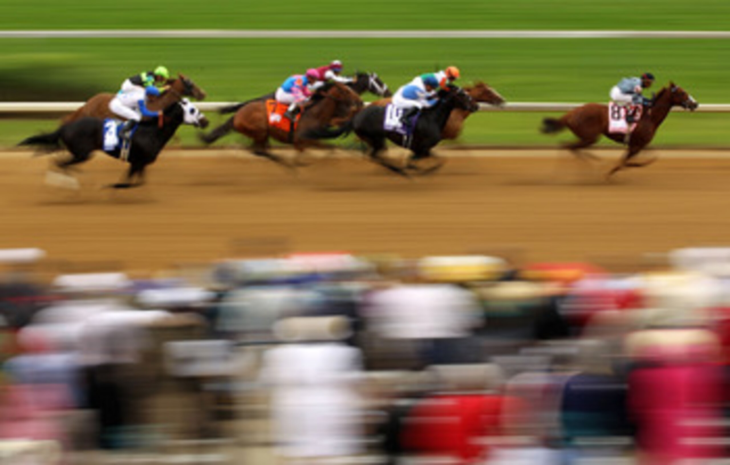 LOUISVILLE, KY - MAY 07:  Horses run down the front stretch as they race during the third race on the day of the 137th Kentucky Derby at Churchill Downs on May 7, 2011 in Louisville, Kentucky.  (Photo by Al Bello/Getty Images)