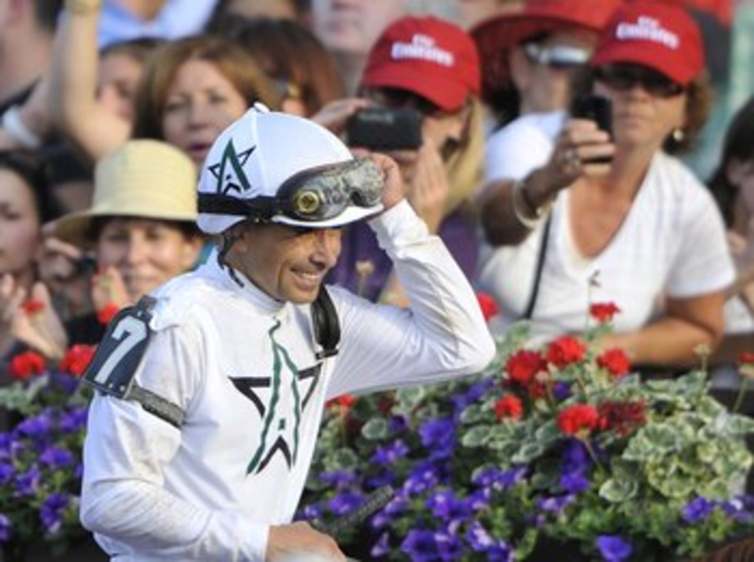 ELMONT, NY - JUNE 05:  Jockey Mike Smith removes waves to the crowd with a smile after riding Drosselmeyer to win the running of the 142nd Belmont Stakes at Belmont Park on June 5, 2010 in Elmont, New York.  (Photo by Paul Bereswill/Getty Images)