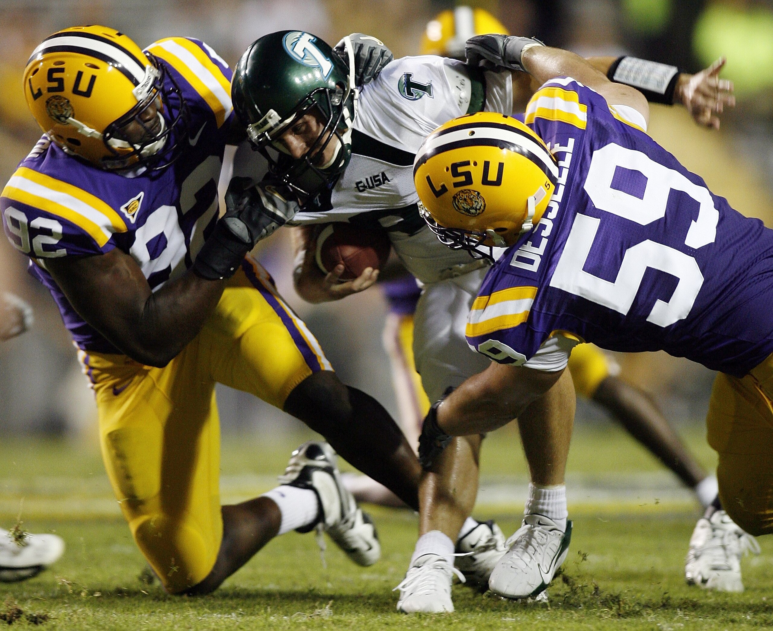 BATON ROUGE, LA - SEPTEMBER 23:  Tim Washington #92 and Leo Desselle #59 of Louisiana State University combine to sack Anthony Scelfo #9 of Tulane University on September 23, 2006 at Tiger Stadium in Baton Rouge, Louisiana. LSU defeated Tulane 49-7. (Phot