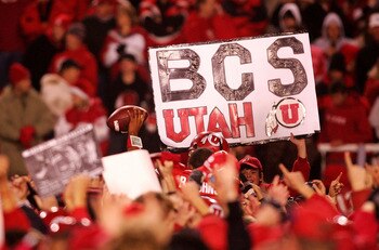 SALT LAKE CITY - NOVEMBER 22:  A fan of the Utah Utes holds a a sign after defeating the BYU Cougars 48-24 to complete a pefect 12-0 season at Rice-Eccles Stadium on November 22, 2008 in Salt Lake City, Utah.  (Photo by Jonathan Ferrey/Getty Images)