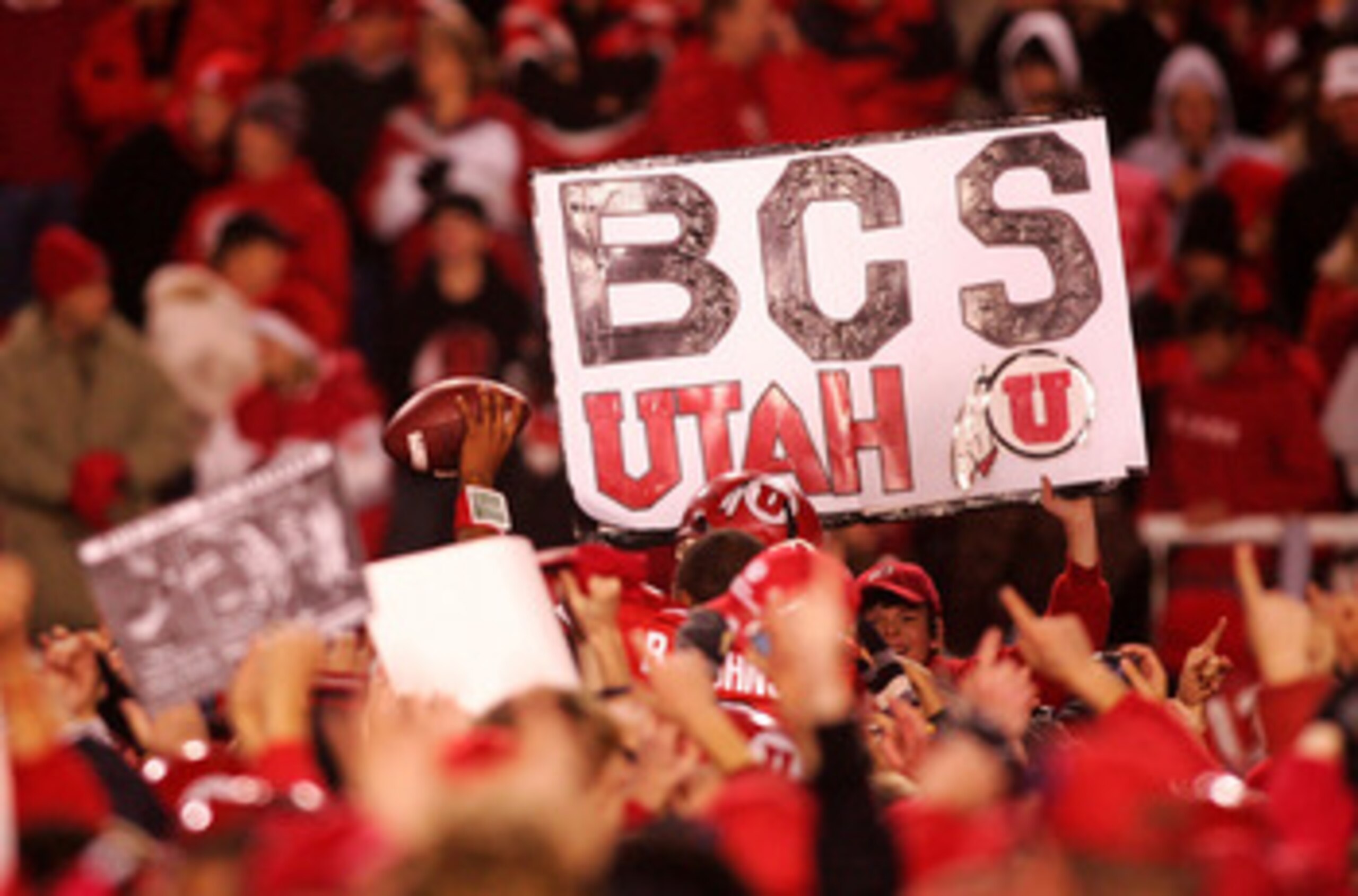 SALT LAKE CITY - NOVEMBER 22:  A fan of the Utah Utes holds a a sign after defeating the BYU Cougars 48-24 to complete a pefect 12-0 season at Rice-Eccles Stadium on November 22, 2008 in Salt Lake City, Utah.  (Photo by Jonathan Ferrey/Getty Images)