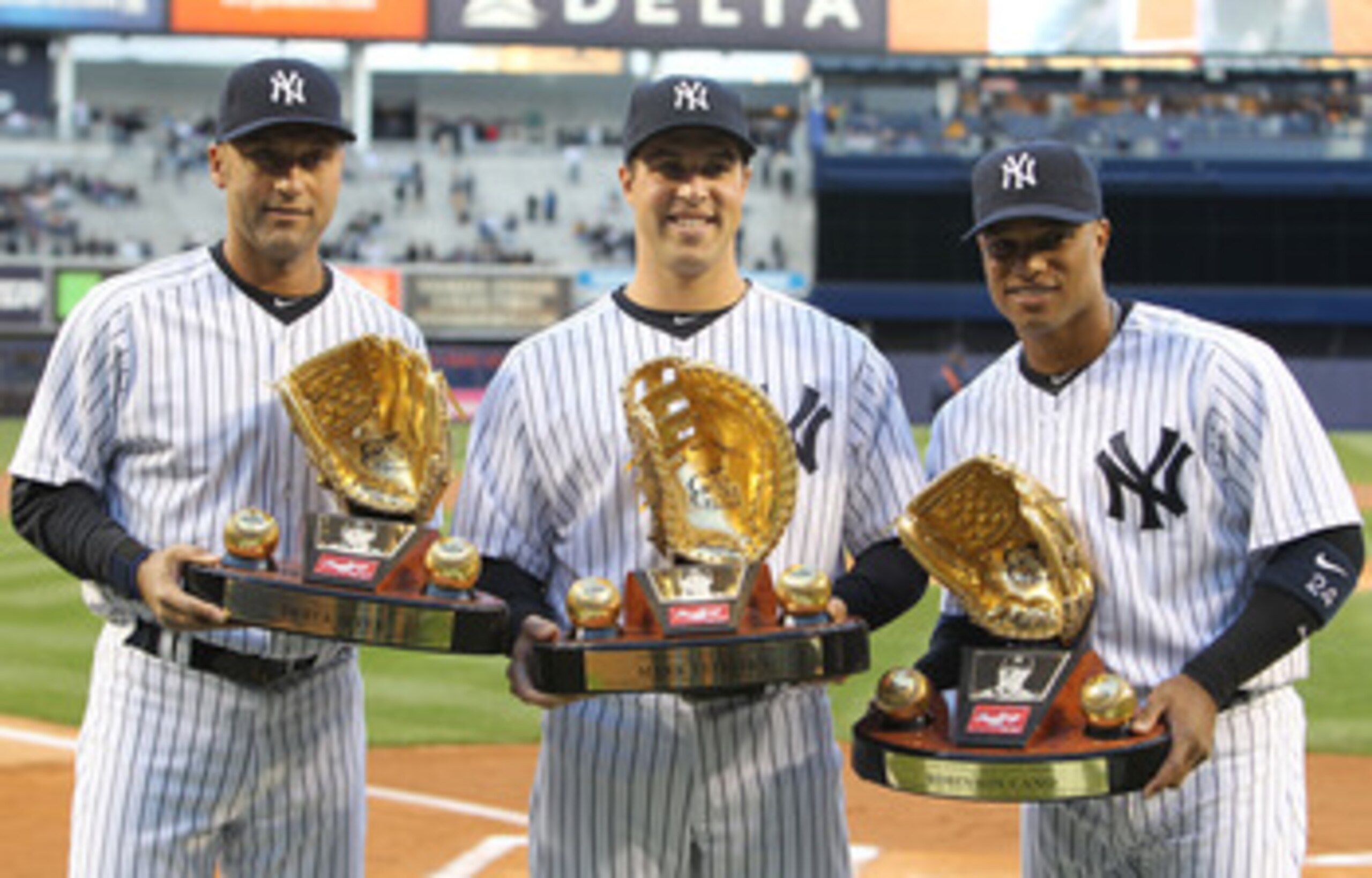 NEW YORK, NY - APRIL 05: (L-R) Derek Jeter #2, Mark Teixeira #25 and Robinson Cano #24 of the New York Yankees pose with their Gold Glove Awards prior to their game against the Minnesota Twins at Yankee Stadium on April 5, 2011 in the Bronx borough of New NEW YORK, NY - APRIL 05: (L-R) Derek Jeter #2, Mark Teixeira #25 and Robinson Cano #24 of the New York Yankees pose with their Gold Glove Awards prior to their game against the Minnesota Twins at Yankee Stadium on April 5, 2011 in the Bronx borough of New