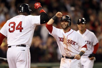 BOSTON, MA - MAY 02:  Dustin Pedroia #15 of the Boston Red Sox is congratulated by teammate David Ortiz #34 after Pedroia and Jacoby Ellsbury scored on a hit by Adrian Gonzalez in the seventh inning against the Los Angeles Angels on May 2, 2011 at Fenway