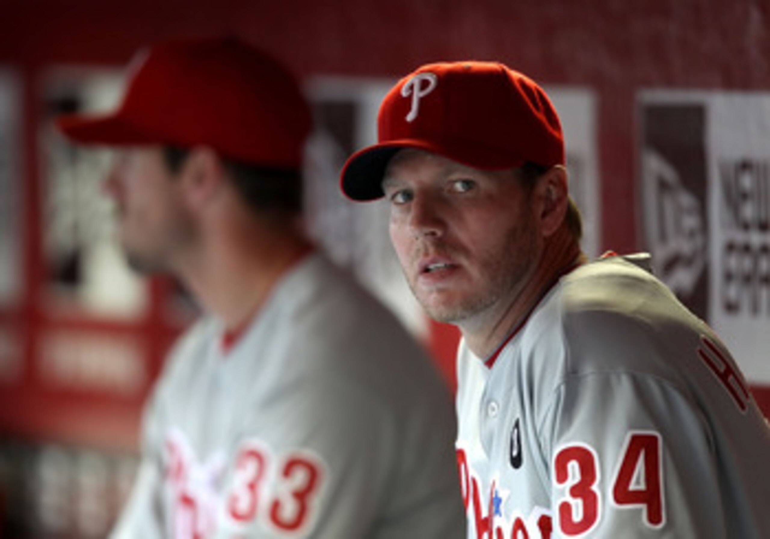PHOENIX, AZ - APRIL 26: Pitcher Roy Halladay #34 (R) and Cliff Lee #33 of the Philadelphia Phillies sit in the dugout during the Major League Baseball game against the Arizona Diamondbacks at Chase Field on April 26, 2011 in Phoenix, Arizona. (Photo by PHOENIX, AZ - APRIL 26: Pitcher Roy Halladay #34 (R) and Cliff Lee #33 of the Philadelphia Phillies sit in the dugout during the Major League Baseball game against the Arizona Diamondbacks at Chase Field on April 26, 2011 in Phoenix, Arizona. (Photo by