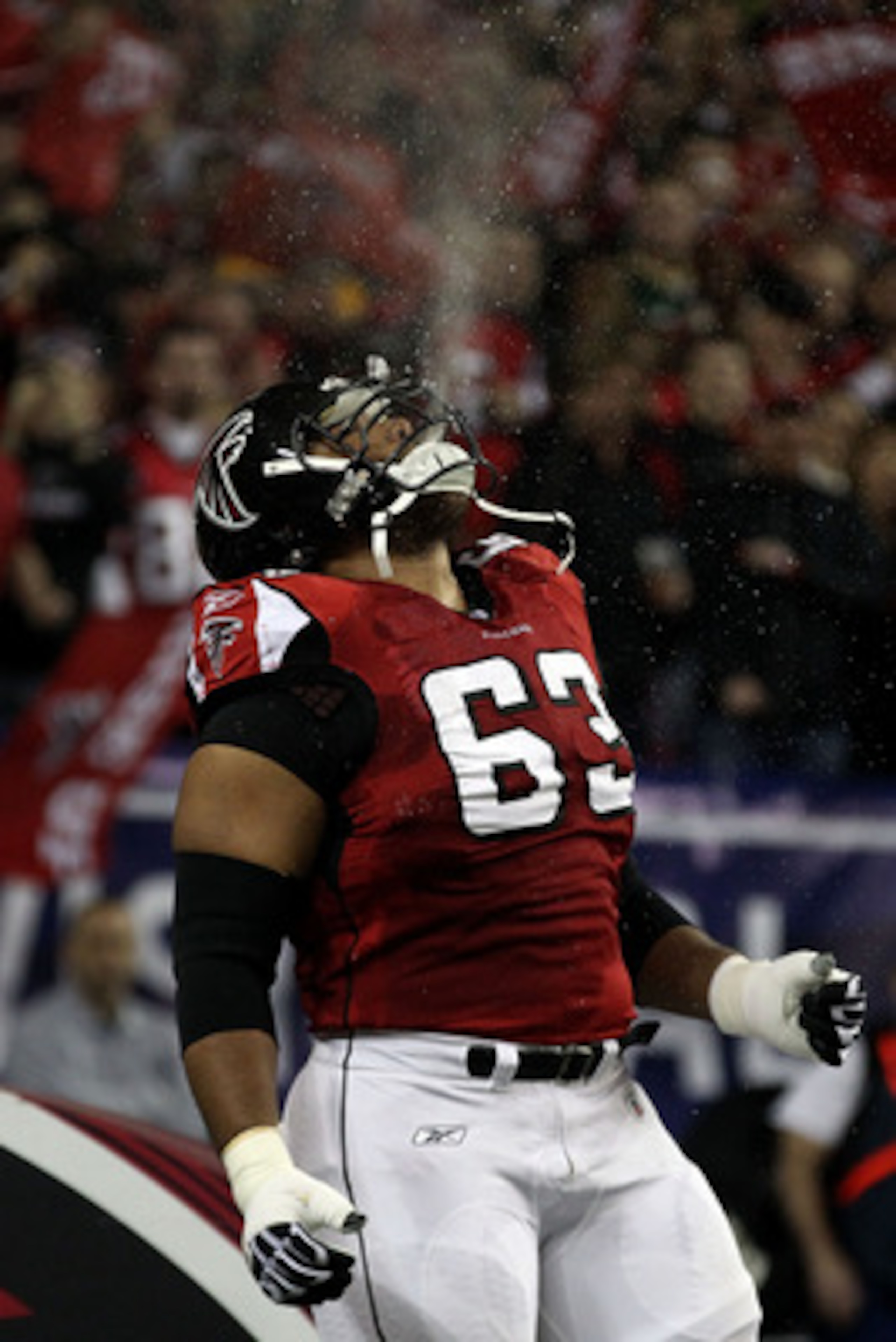 ATLANTA, GA - JANUARY 15: Justin Blalock #63 of the Atlanta Falcons spits water in the air as he runs onto the field during player introductions against the Green Bay Packers during their 2011 NFC divisional playoff game at Georgia Dome on January 15, 20 ATLANTA, GA - JANUARY 15: Justin Blalock #63 of the Atlanta Falcons spits water in the air as he runs onto the field during player introductions against the Green Bay Packers during their 2011 NFC divisional playoff game at Georgia Dome on January 15, 20