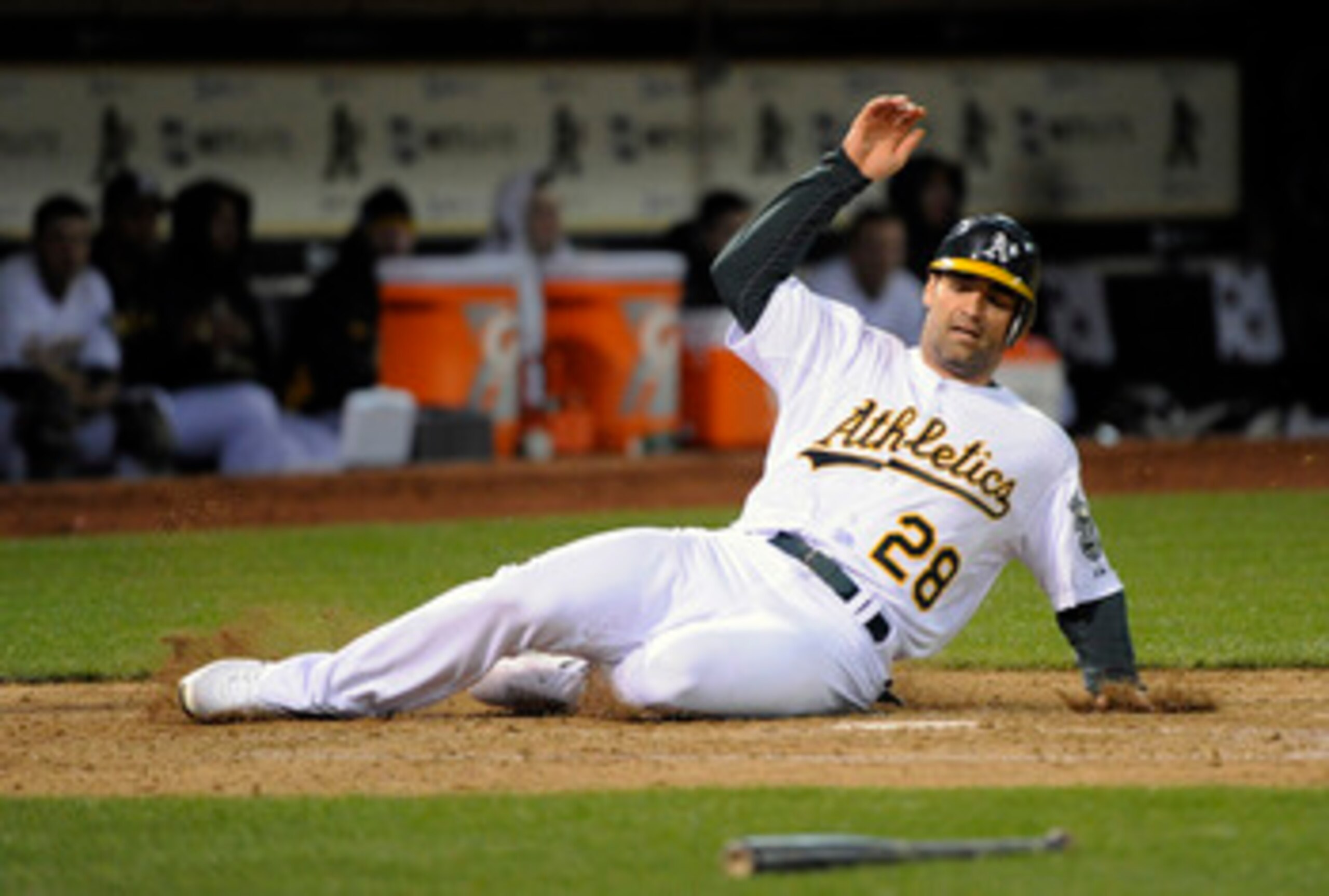 OAKLAND, CA - APRIL 29: Conor Jackson #28 of the Oakland Athletics scores on Josh Willingham's double in the bottom of the fifth inning against the Texas Rangers during a MLB baseball game at the Oakland-Alameda County Coliseum April 29, 2011 in Oakland,