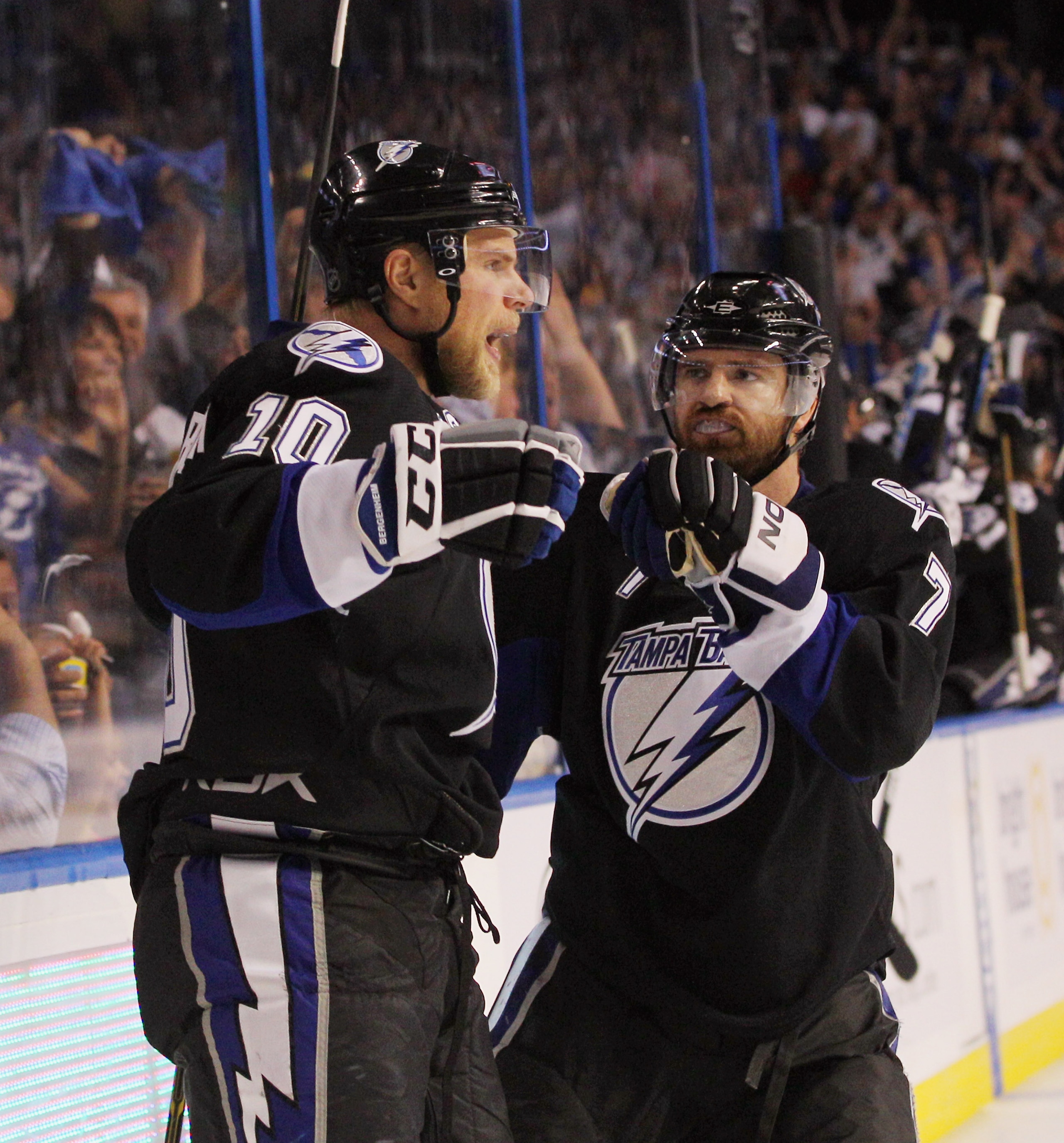 TAMPA, FL - MAY 04:  Sean Bergenheim #10 of the Tampa Bay Lightning scores at 4:41 of the second period against the Washington Capitals and is joined by Brett Clark #7 in Game Four of the Eastern Conference Semifinals during the 2011 NHL Stanley Cup Playo