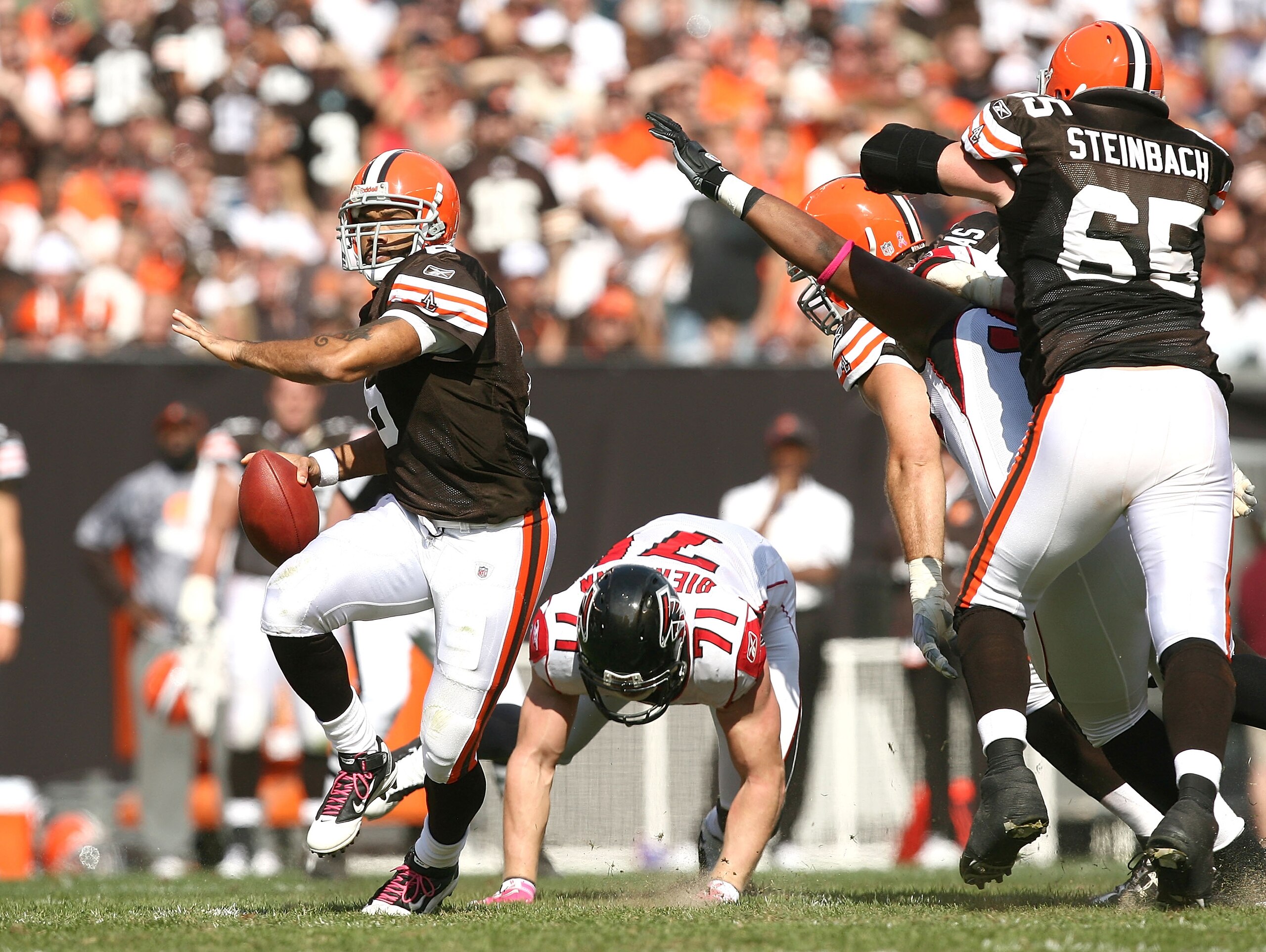 CLEVELAND - OCTOBER 10:  Quarterback Seneca Wallace #6 of the Cleveland Browns gets a block from Eric Steinbach #65 as he runs from defender Kroy Biermann #71 of the Atlanta Falcons at Cleveland Browns Stadium on October 10, 2010 in Cleveland, Ohio.  (Pho