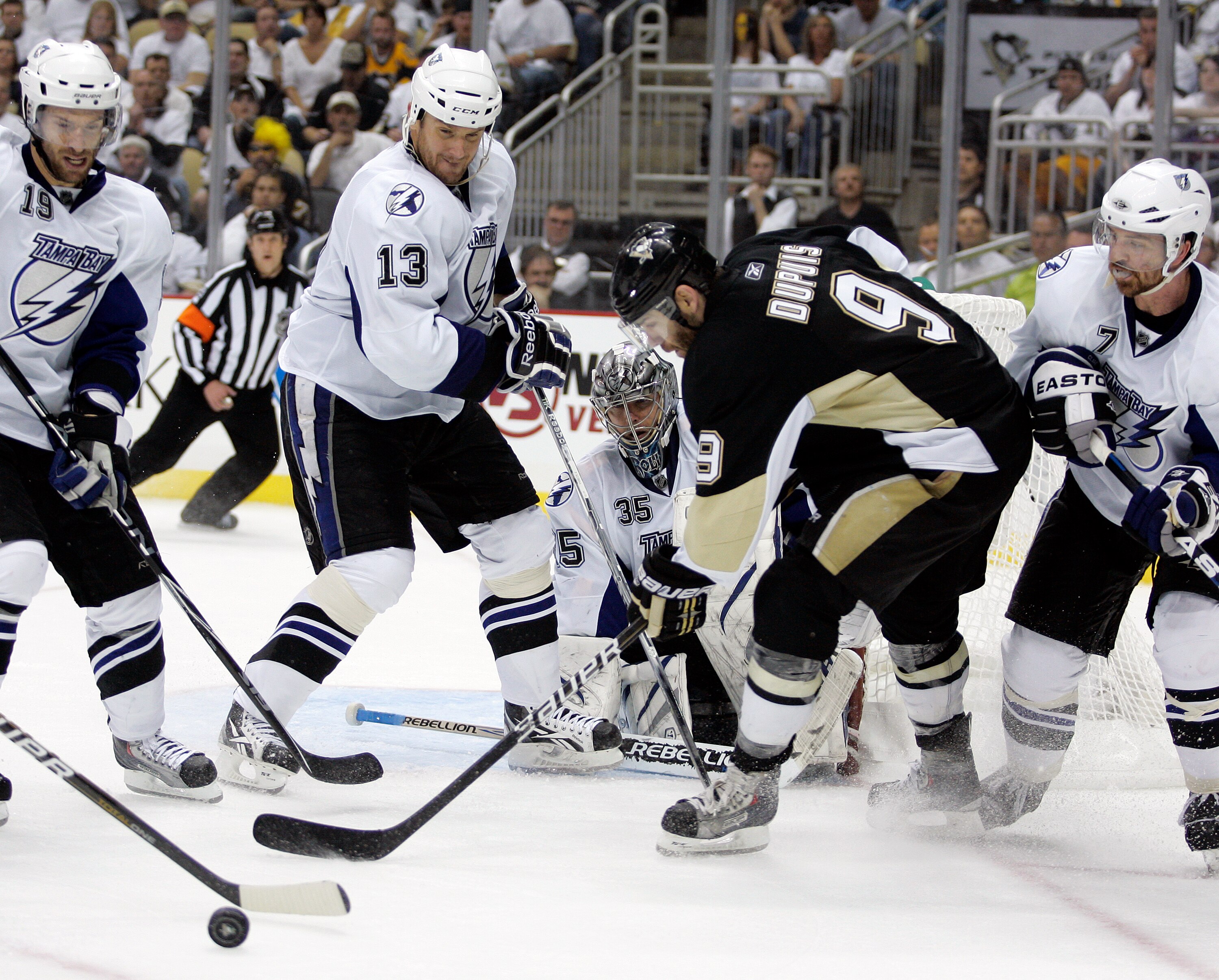 PITTSBURGH, PA - APRIL 27:  Dwayne Roloson #35 of the Tampa Bay Lightning makes a save on Pascal Dupuis #9 of the Pittsburgh Penguins in Game Seven of the Eastern Conference Quarterfinals during the 2011 NHL Stanley Cup Playoffs at Consol Energy Center on
