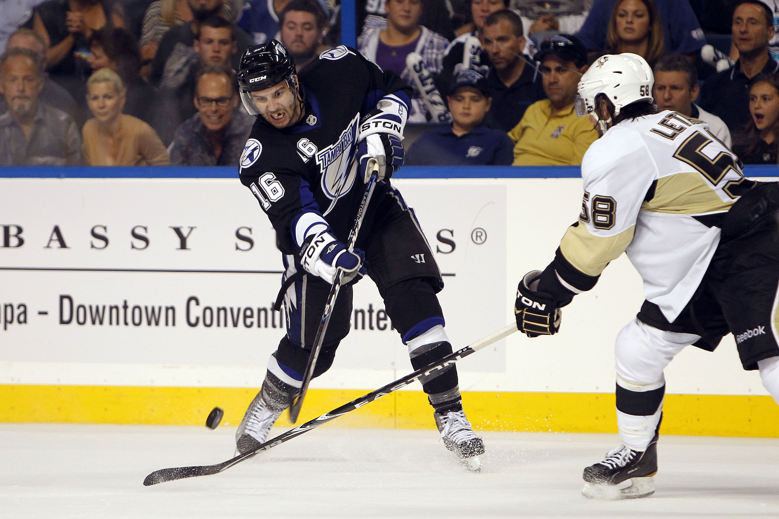 TAMPA, FL - APRIL 20: Teddy Purcell #16 of the Tampa Bay Lightning passes the puck against Kris Letang #58 of the Pittsburgh Penguins in Game Four of the Eastern Conference Quarterfinals during the 2011 NHL Stanley Cup Playoffs at the St. Pete Times Forum