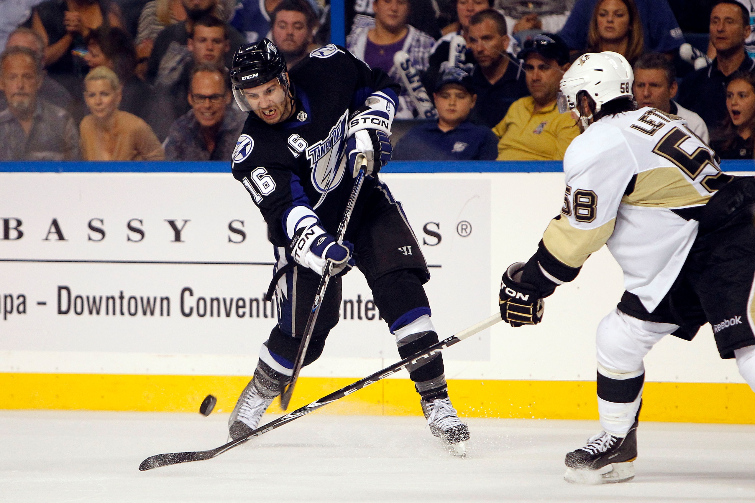 TAMPA, FL - APRIL 20: Teddy Purcell #16 of the Tampa Bay Lightning passes the puck against Kris Letang #58 of the Pittsburgh Penguins in Game Four of the Eastern Conference Quarterfinals during the 2011 NHL Stanley Cup Playoffs at the St. Pete Times Forum
