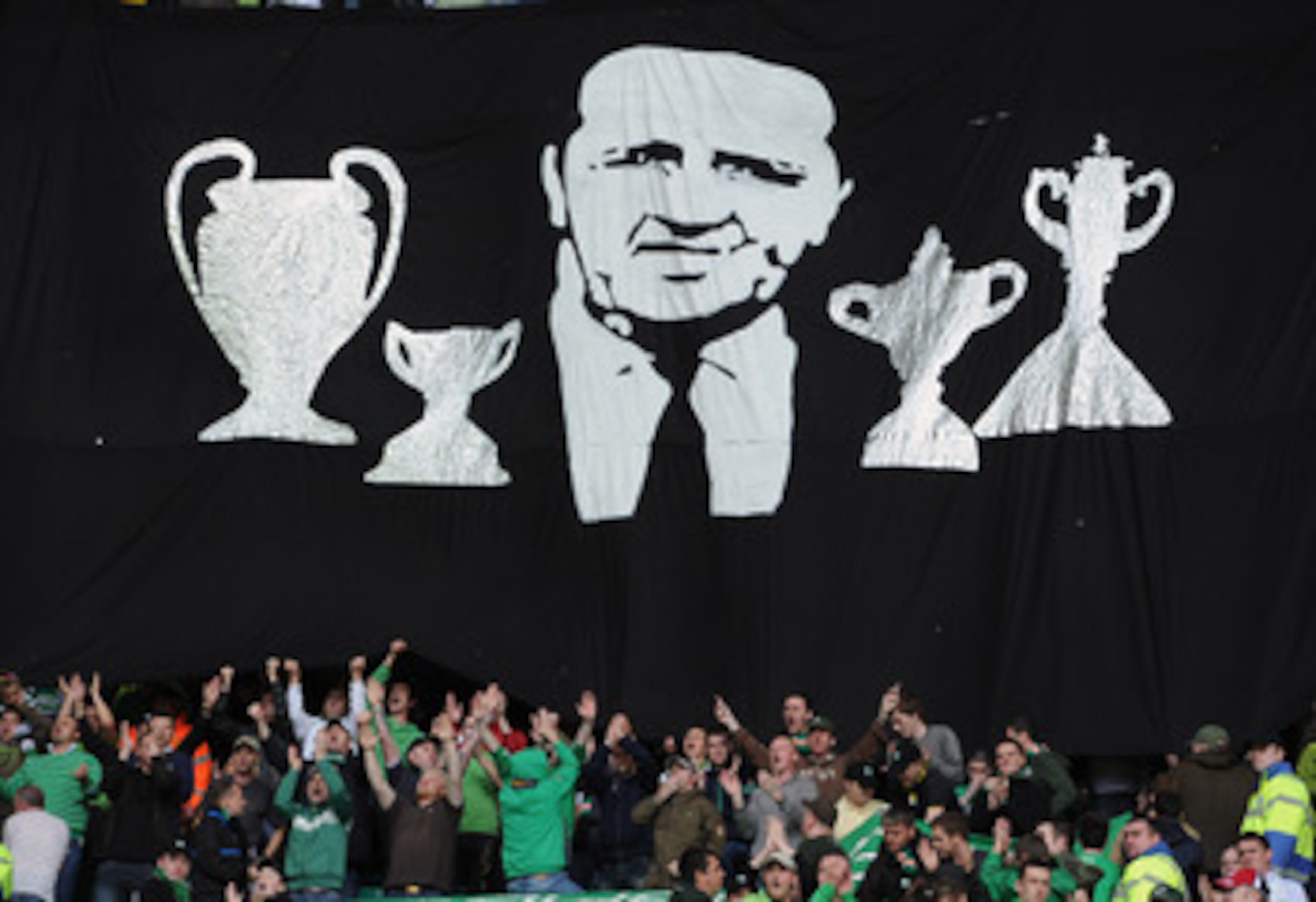 GLASGOW, SCOTLAND - SEPTEMBER 11: Celtic fans hold a minute's applause prior to the Clydesdale Bank Premier League match between Celtic and Hearts to mark the 25th anniversary of Jock Stein's death at Celtic Park on September 11, 2010 in Glasgow, Scotlan GLASGOW, SCOTLAND - SEPTEMBER 11: Celtic fans hold a minute's applause prior to the Clydesdale Bank Premier League match between Celtic and Hearts to mark the 25th anniversary of Jock Stein's death at Celtic Park on September 11, 2010 in Glasgow, Scotlan