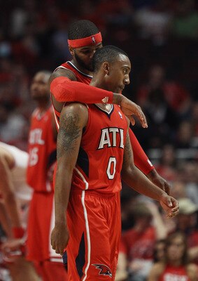 CHICAGO, IL - MAY 02: Josh Smith #5 of the Atlanta Hawks hugs teammate Jeff Teague #0 in the closing minute of a win over the Chicago Bulls in Game One of the Eastern Conference Semifinals in the 2011 NBA Playoffs at the United Center on May 2, 2011 in Ch
