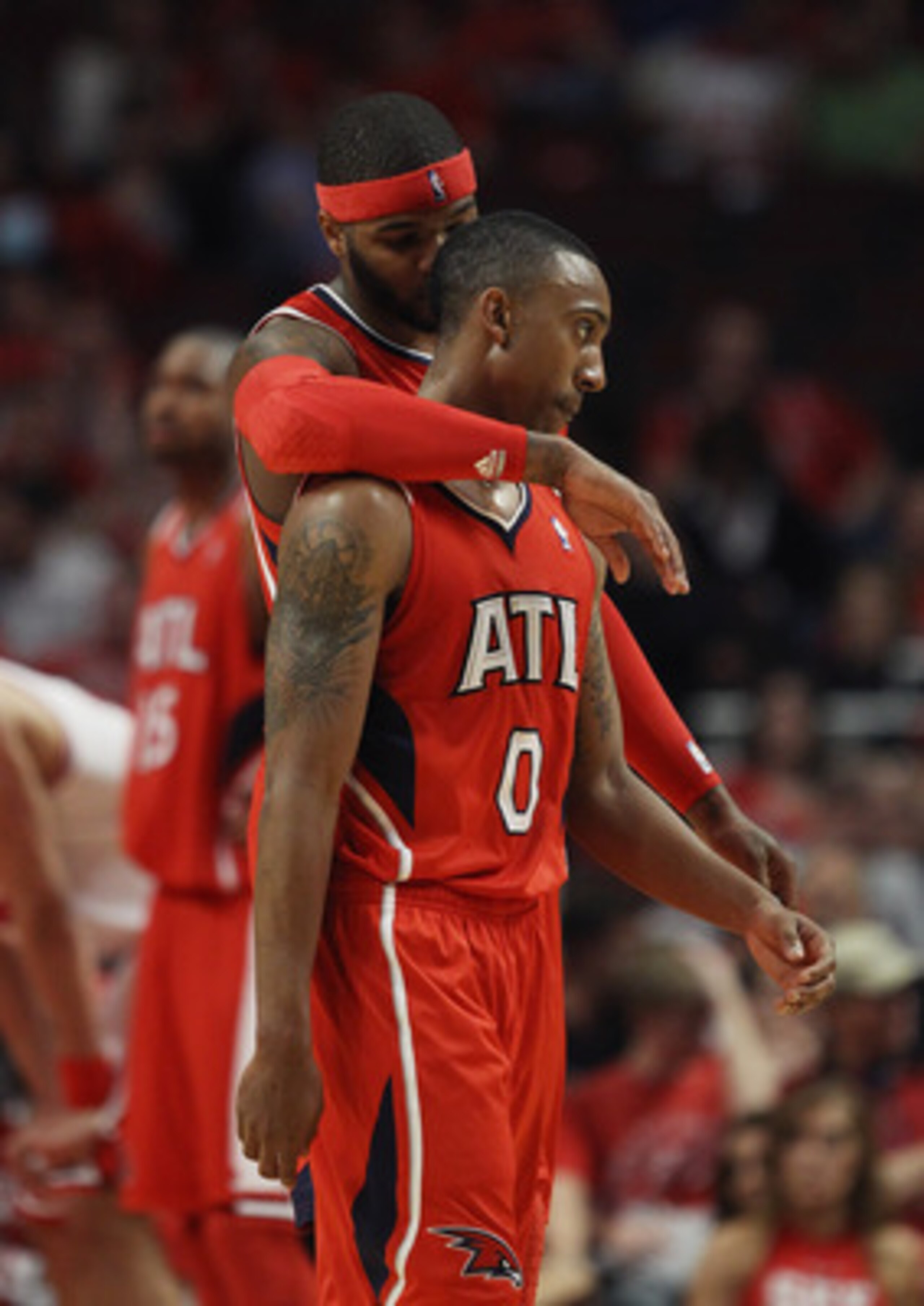 CHICAGO, IL - MAY 02: Josh Smith #5 of the Atlanta Hawks hugs teammate Jeff Teague #0 in the closing minute of a win over the Chicago Bulls in Game One of the Eastern Conference Semifinals in the 2011 NBA Playoffs at the United Center on May 2, 2011 in Ch