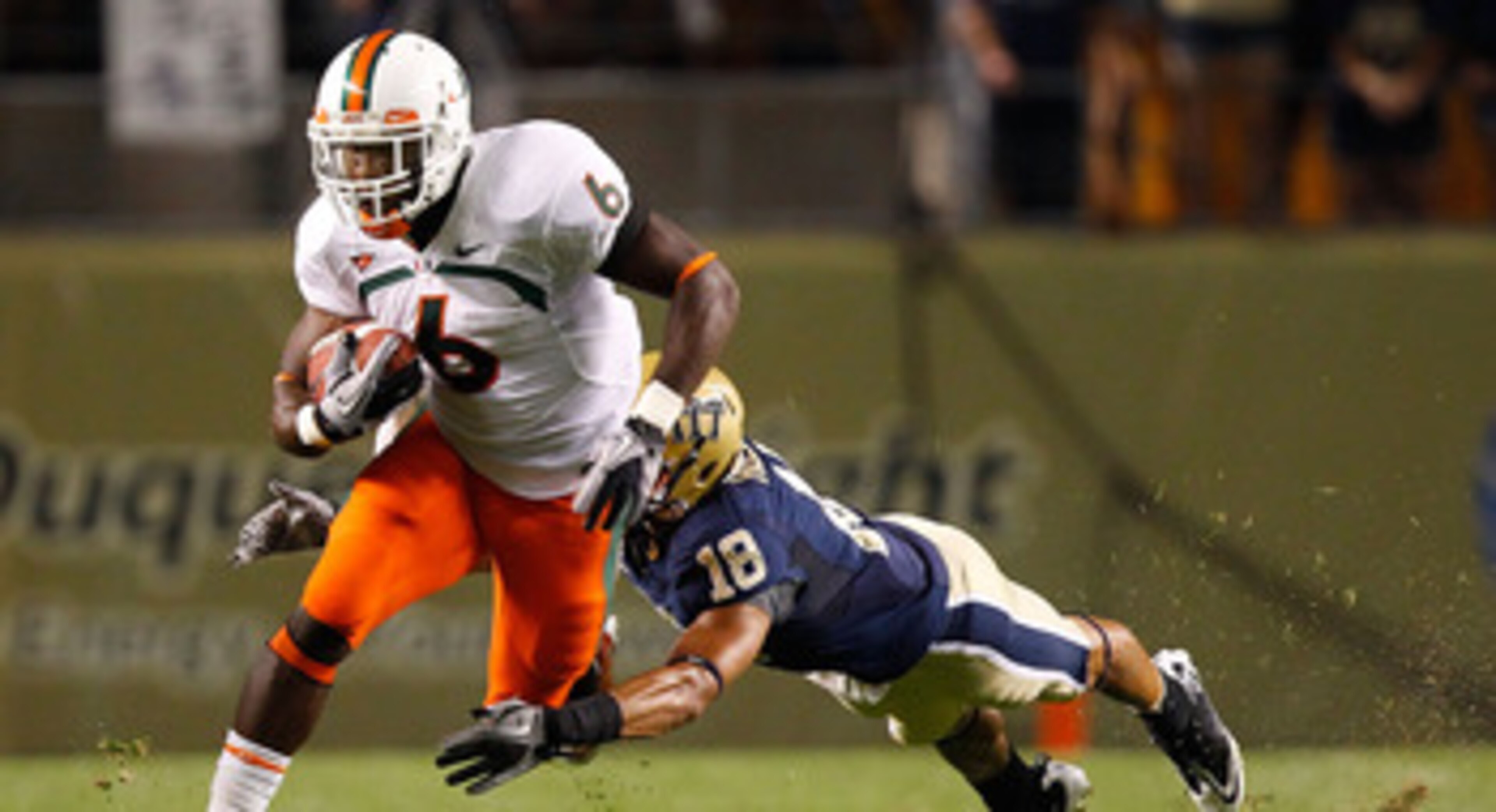 PITTSBURGH - SEPTEMBER 23:  Lamar Miller #6 of the Miami Hurricanes runs through an attempted tackle by Jarred Holley #18 of the Pittsburgh Panthers on September 23, 2010 at Heinz Field in Pittsburgh, Pennsylvania.  (Photo by Jared Wickerham/Getty Images)