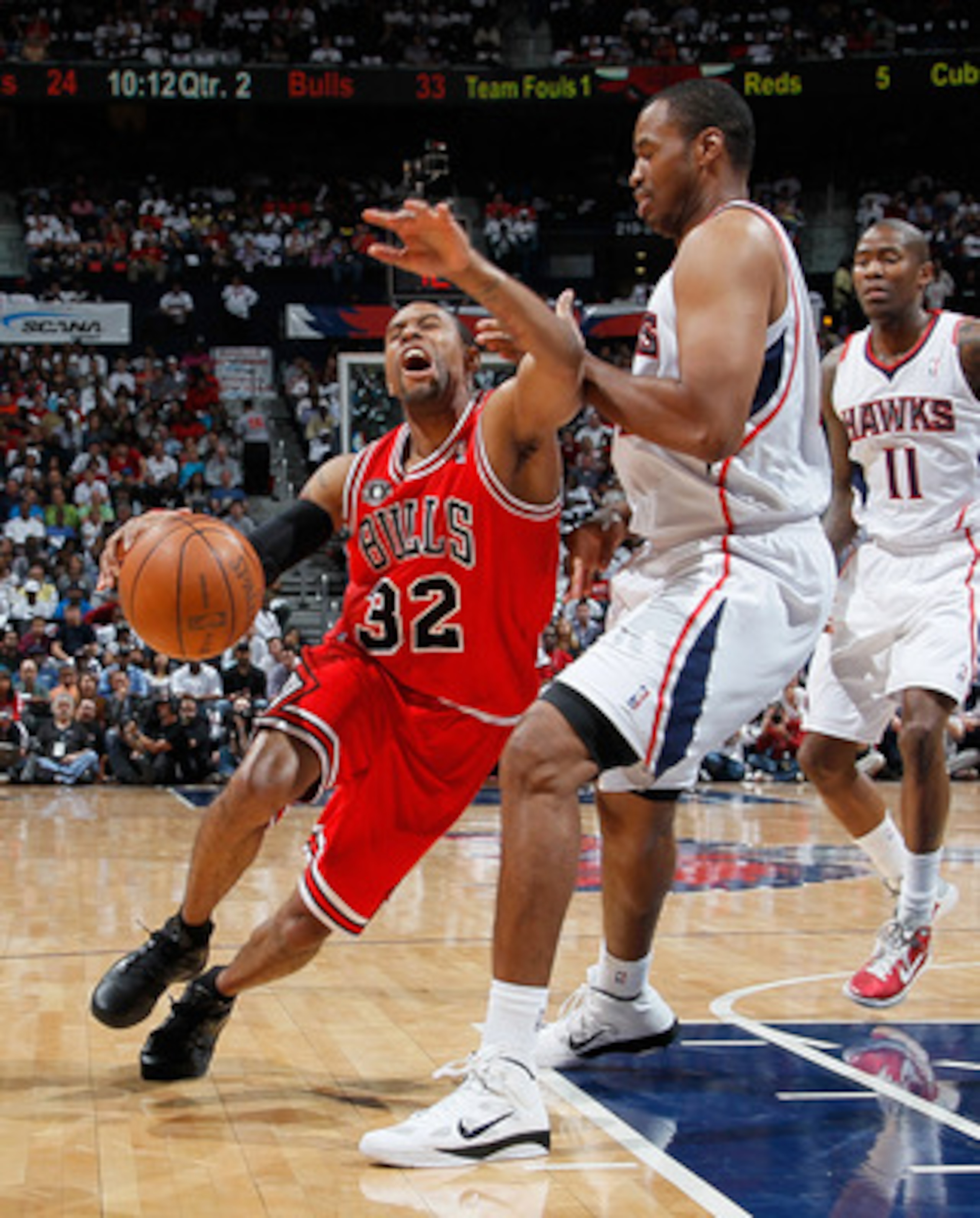 ATLANTA, GA - MAY 06:  C.J. Watson #32 of the Chicago Bulls draws a foul from Jason Collins #34 of the Atlanta Hawks in Game Three of the Eastern Conference Semifinals in the 2011 NBA Playoffs at Phillips Arena on May 6, 2011 in Atlanta, Georgia.  NOTE TO