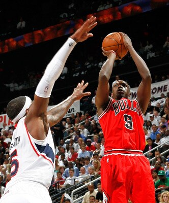 ATLANTA, GA - MAY 06:  Luol Deng #9 of the Chicago Bulls shoots over Josh Smith #5 of the Atlanta Hawks in Game Three of the Eastern Conference Semifinals in the 2011 NBA Playoffs at Phillips Arena on May 6, 2011 in Atlanta, Georgia.  NOTE TO USER: User e