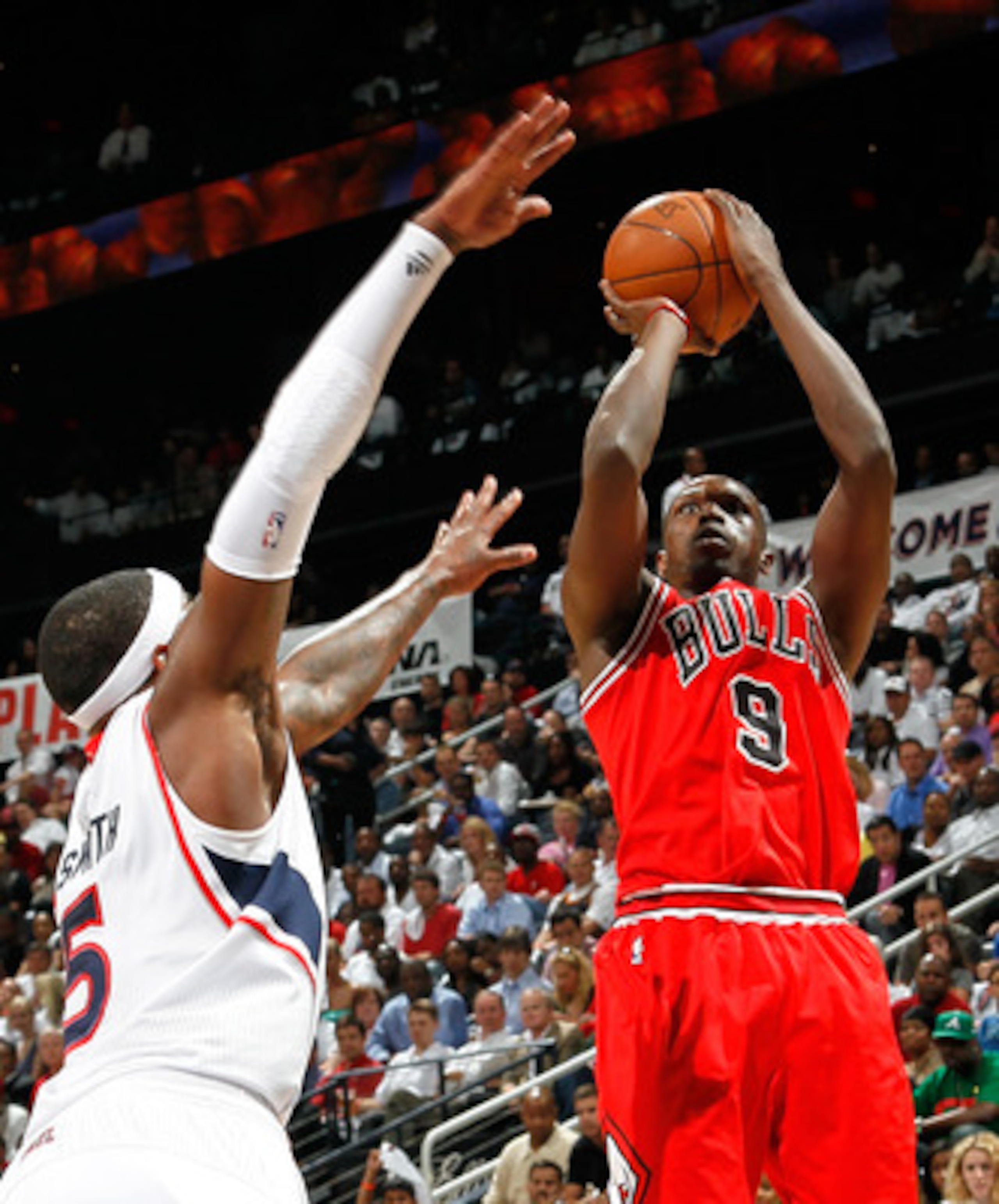 ATLANTA, GA - MAY 06:  Luol Deng #9 of the Chicago Bulls shoots over Josh Smith #5 of the Atlanta Hawks in Game Three of the Eastern Conference Semifinals in the 2011 NBA Playoffs at Phillips Arena on May 6, 2011 in Atlanta, Georgia.  NOTE TO USER: User e