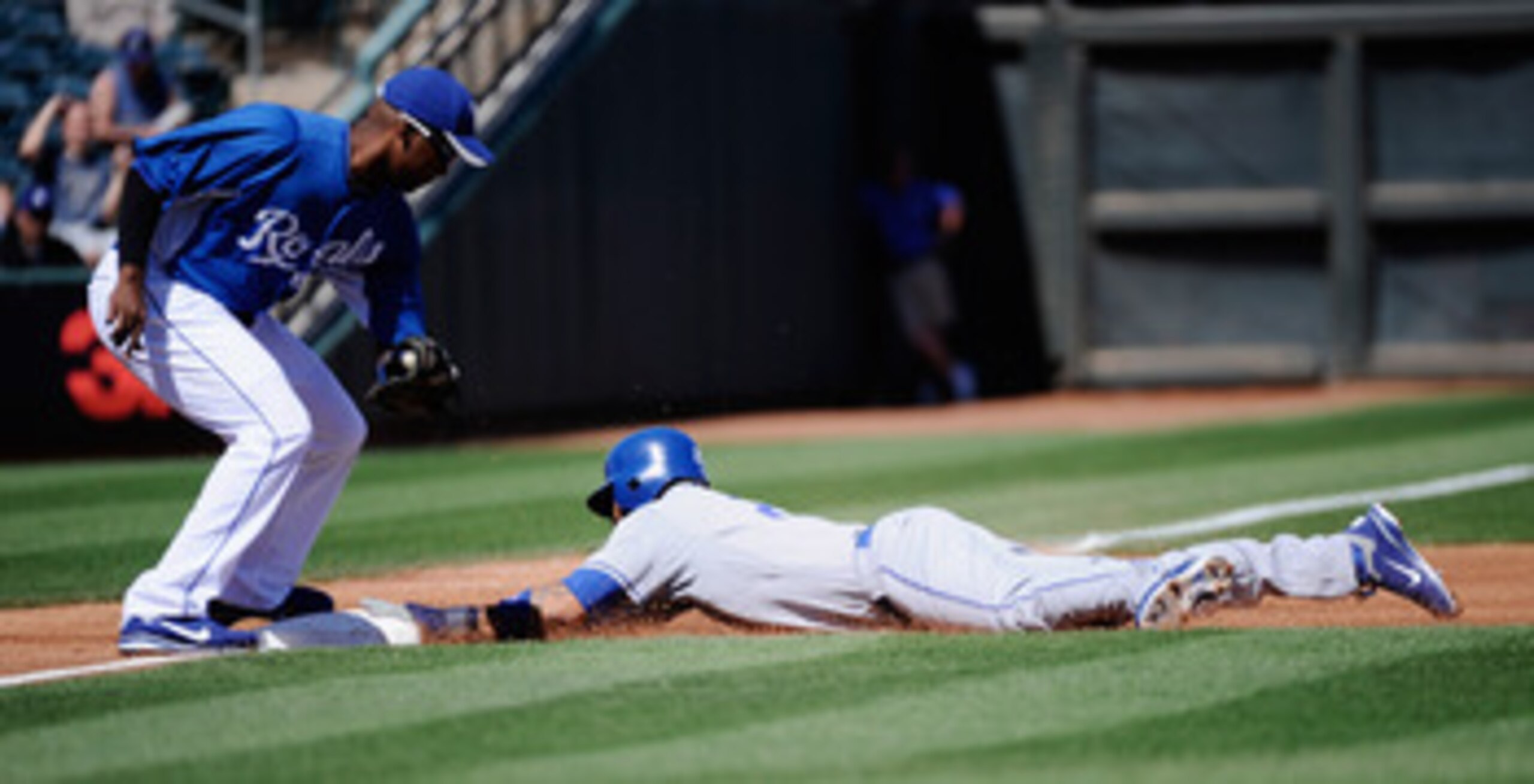 SURPRISE, AZ - MARCH 12:  Matt Kemp #27 of the the Los Angeles Dodgers dives into third base to steal during the first inning of the spring training baseball game against the Kansas City Royals  at Surprise Stadium on March 12, 2011 in Surprise, Arizona.