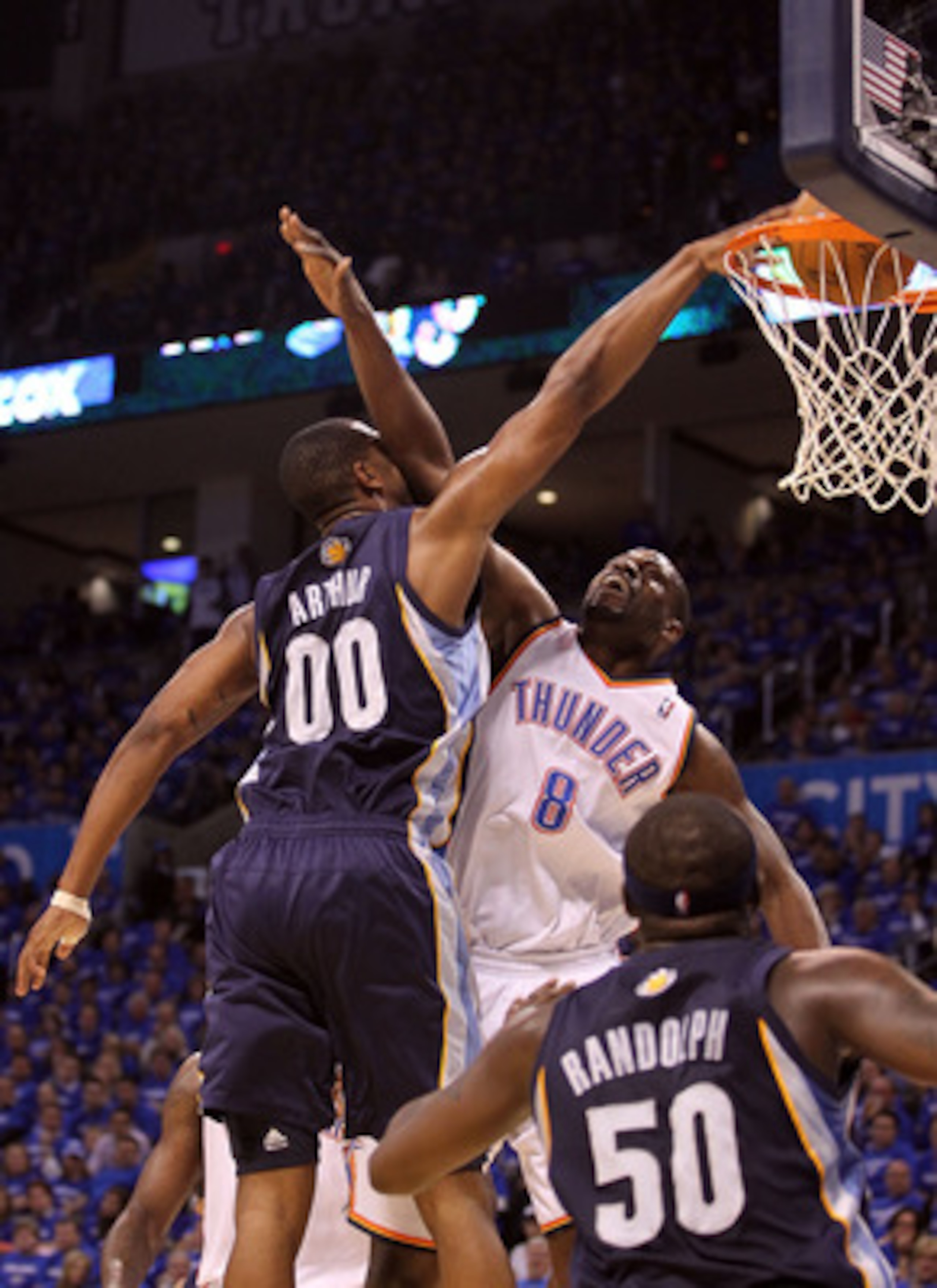 OKLAHOMA CITY, OK - MAY 03:  Forward Darrell Arthur #00 of the Memphis Grizzlies makes the slam dunk against Nazr Mohammed #8 of the Oklahoma City Thunder in Game Two of the Western Conference Semifinals in the 2011 NBA Playoffs on May 3, 2011 at Oklahoma