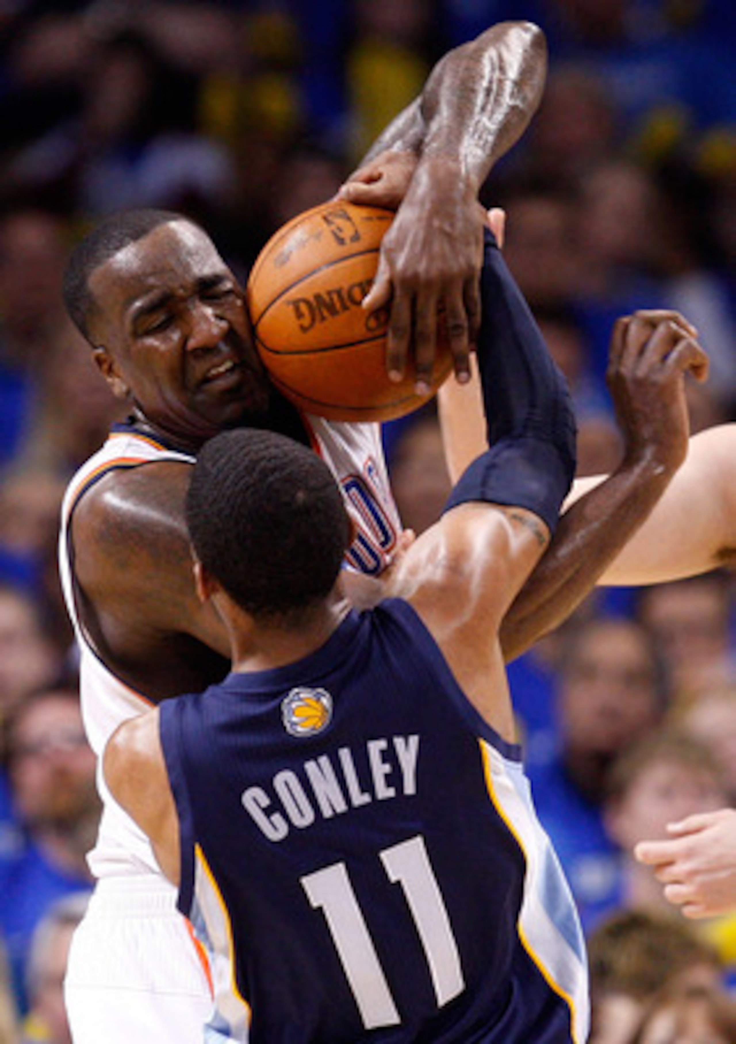 OKLAHOMA CITY, OK - MAY 03:  Center Kendrick Perkins #5 of the Oklahoma City Thunder battles for the ball with Mike Conley #11 of the Memphis Grizzlies in Game Two of the Western Conference Semifinals in the 2011 NBA Playoffs on May 3, 2011 at Oklahoma Ci