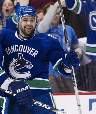 VANCOUVER, CANADA - APRIL 28: Chris Higgins #20 (R) celebrates with Dan Hamhuis #2 of the Vancouver Canucks after scoring against the Nashville Predators during the second period in Game One of the Western Conference Semifinals during the 2011 NHL Stanley