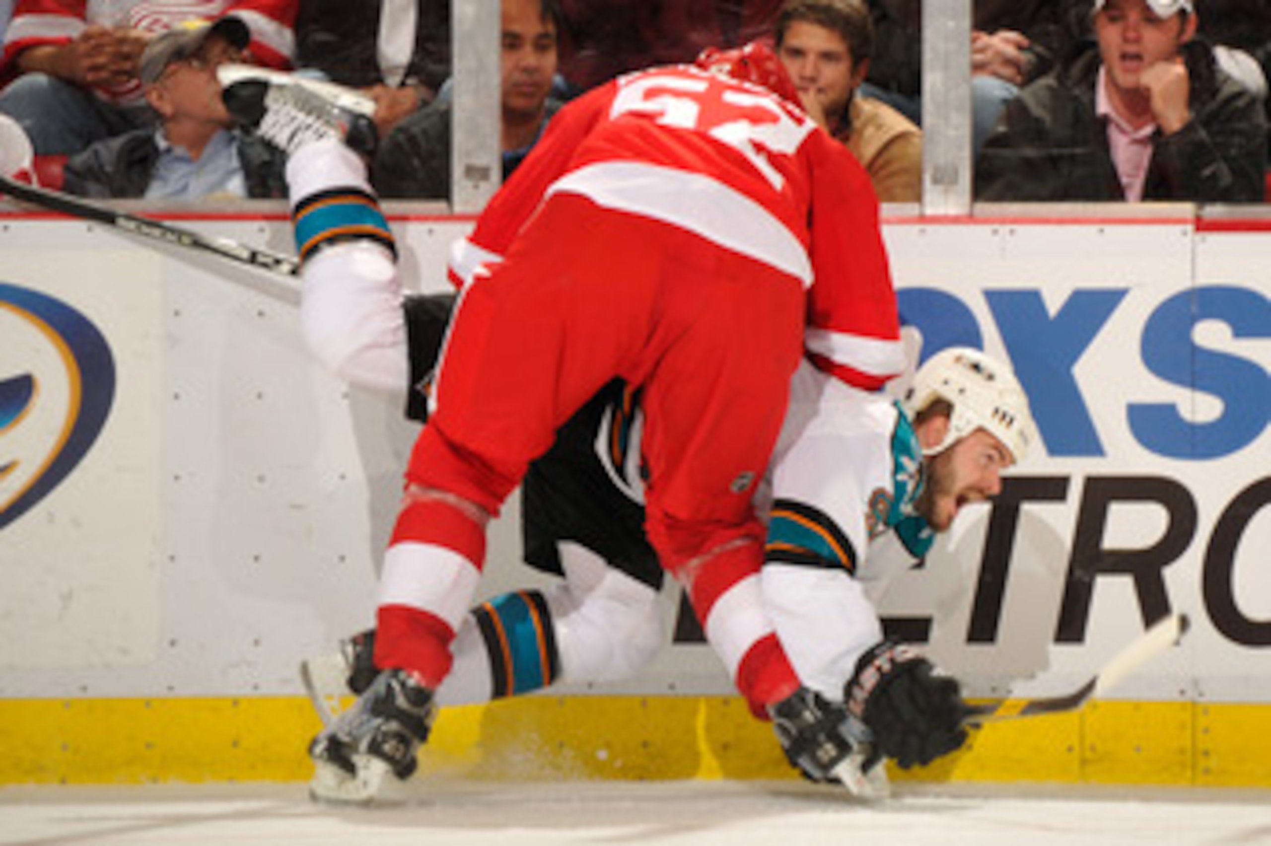 DETROIT - MAY 4:  Jonathan Ericsson #52 of the Detroit Red Wings checks Ian White #9 of the San Jose Sharks in the third period in Game Three of the Western Conference Semifinals during the 2011 NHL Stanley Cup Playoffs on May 4, 2011 at Joe Louis Arena i