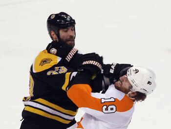BOSTON, MA - MAY 06:  Zdeno Chara #33 of the Boston Bruins exchanges blows with Scott Hartnell #19 of the Philadelphia Flyers in Game Four of the Eastern Conference Semifinals during the 2011 NHL Stanley Cup Playoffs at TD Garden on May 6, 2011 in Boston,