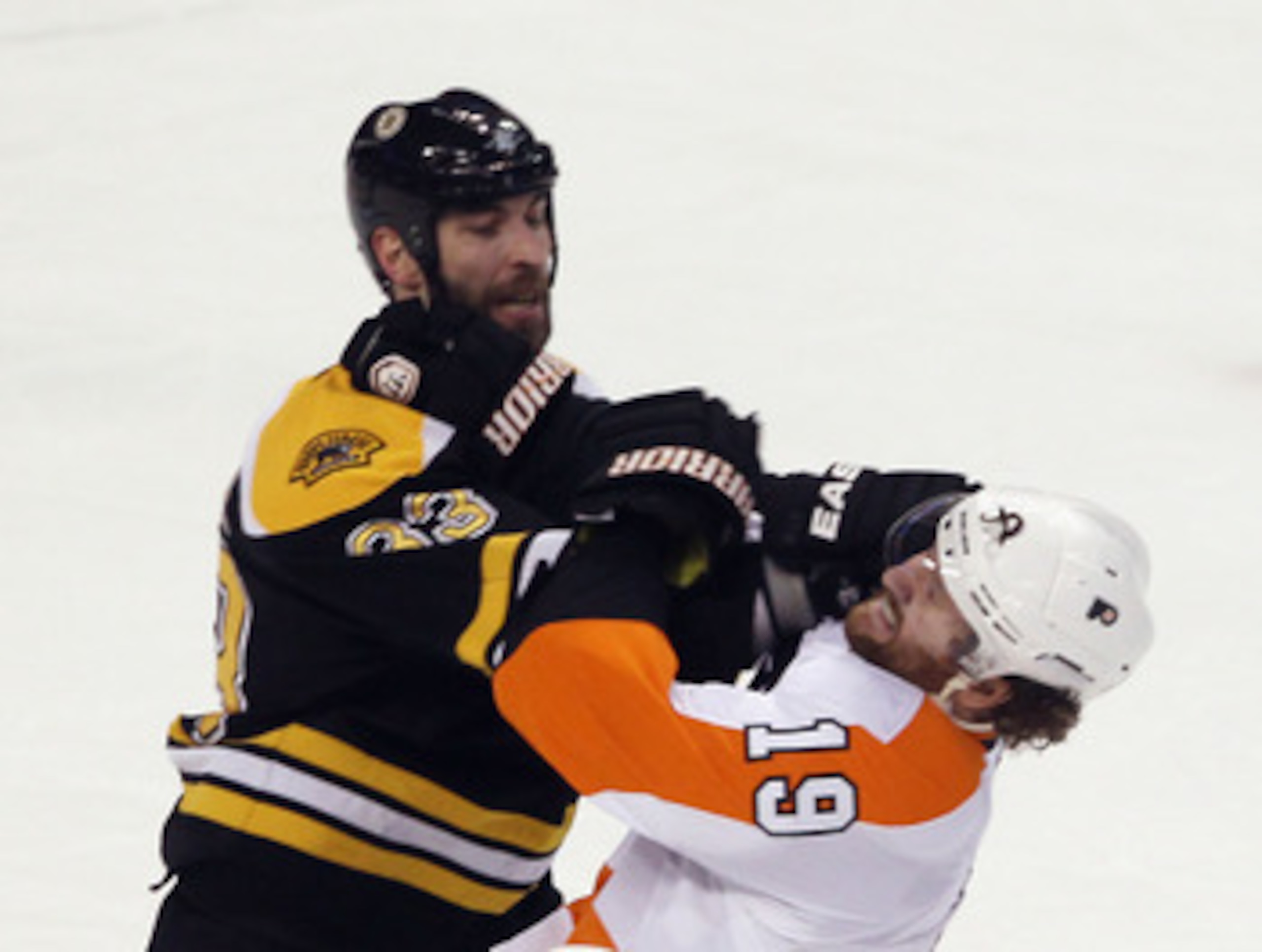 BOSTON, MA - MAY 06:  Zdeno Chara #33 of the Boston Bruins exchanges blows with Scott Hartnell #19 of the Philadelphia Flyers in Game Four of the Eastern Conference Semifinals during the 2011 NHL Stanley Cup Playoffs at TD Garden on May 6, 2011 in Boston,