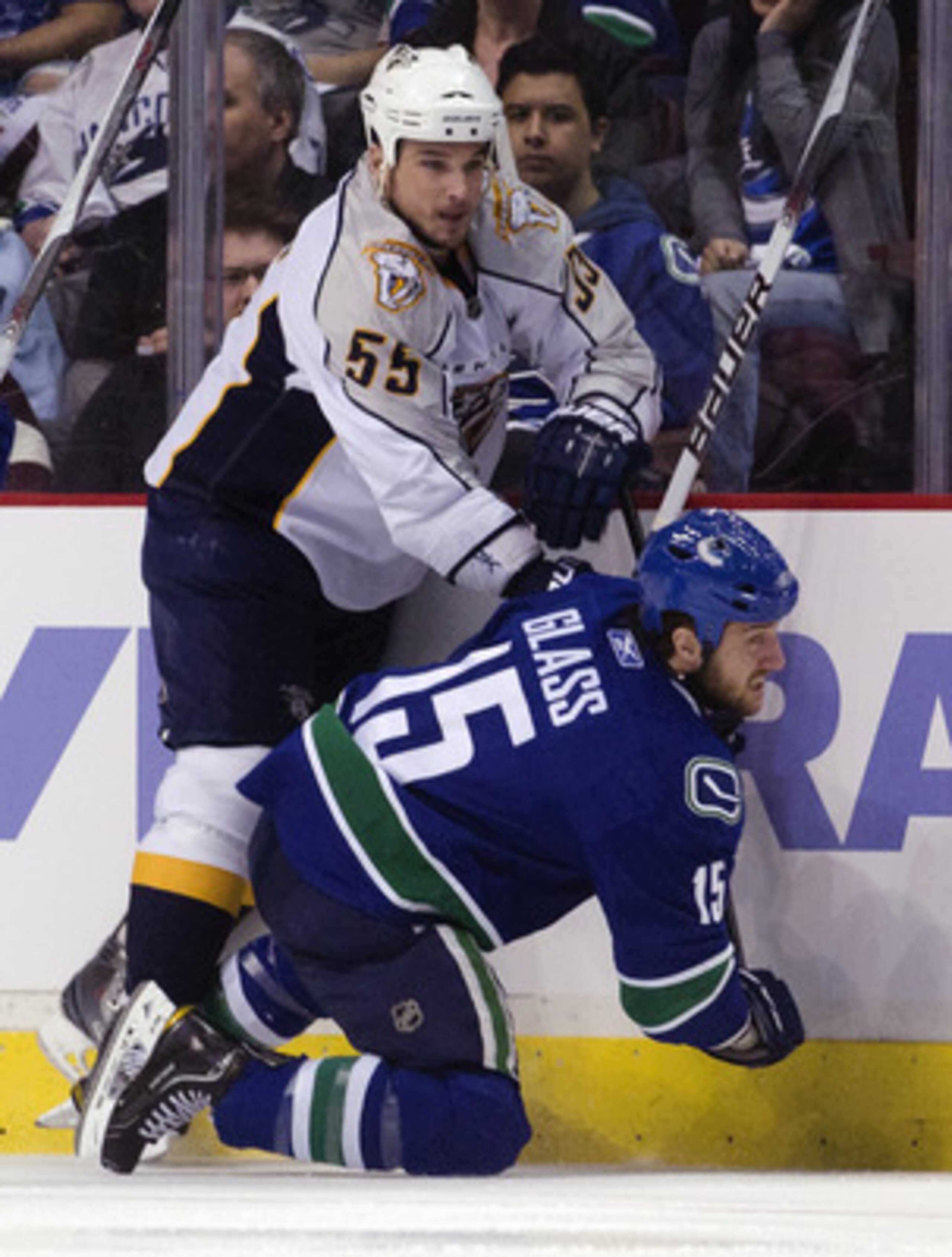 VANCOUVER, CANADA - APRIL 30: Shane O'Brien #55 of the Nashville Predators knocks Tanner Glass #15 of the Vancouver Canucks  down onto the ice during the first period in Game Two of the Western Conference Semifinals during the 2011 NHL Stanley Cup Playoff